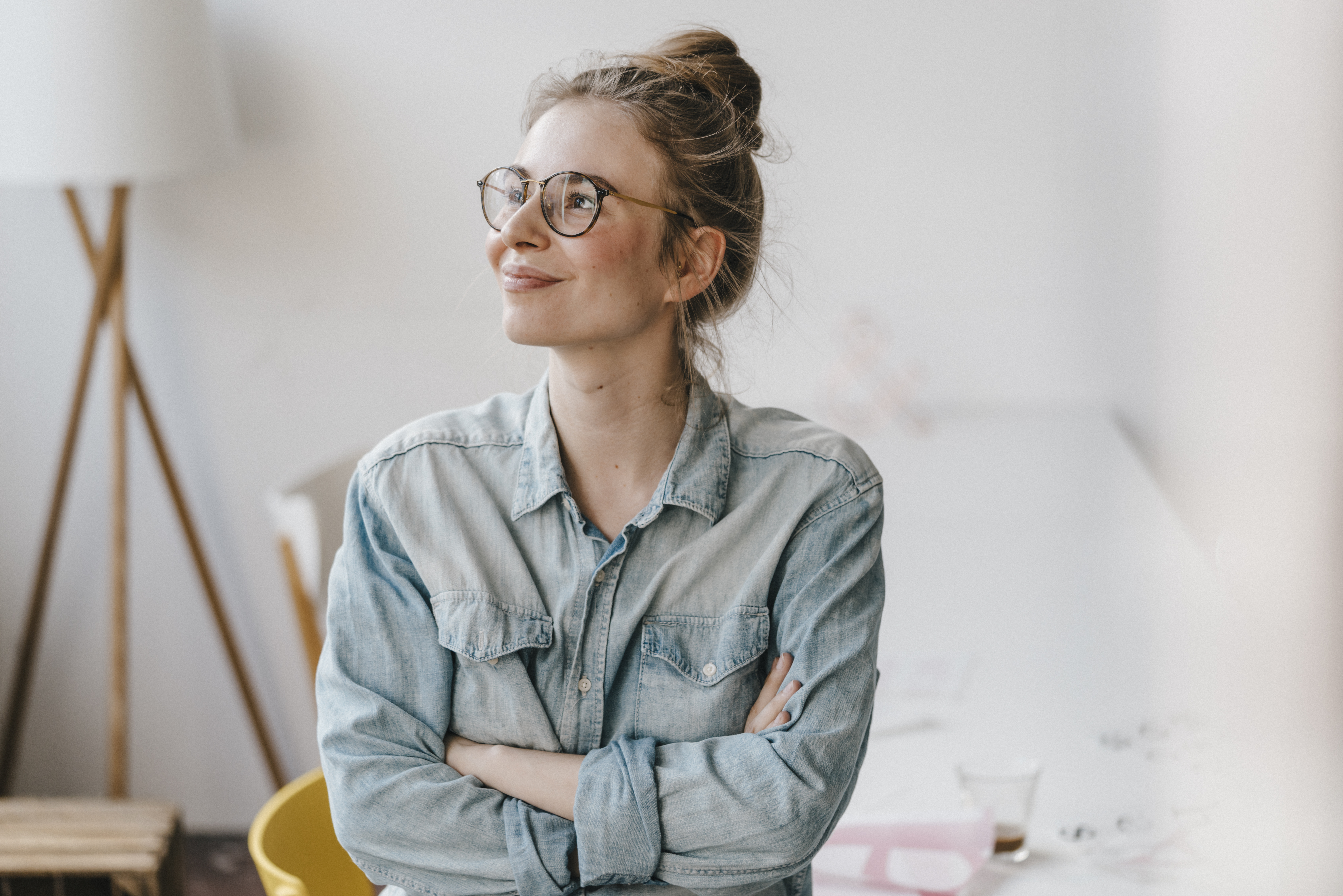 Smiling young woman in office looking sideways | Source: Getty Images