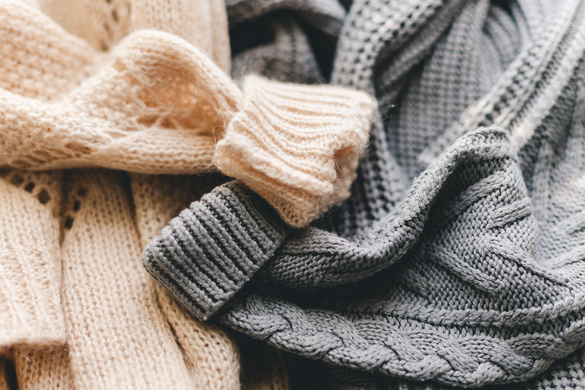 A pair of knitted sweaters | Source: Getty Images
