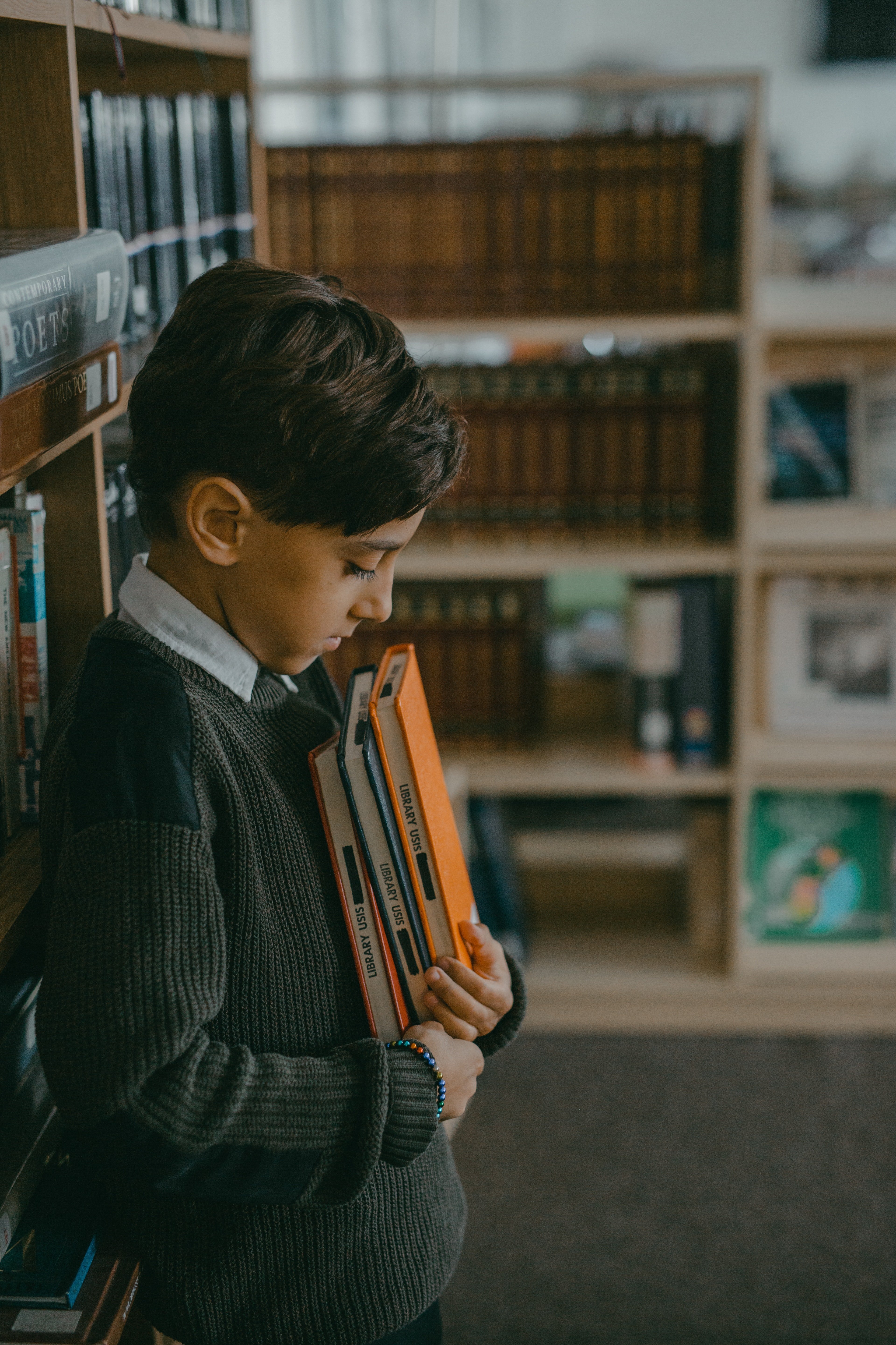 Un niño con algunos libros en sus manos. | Foto: Pexels