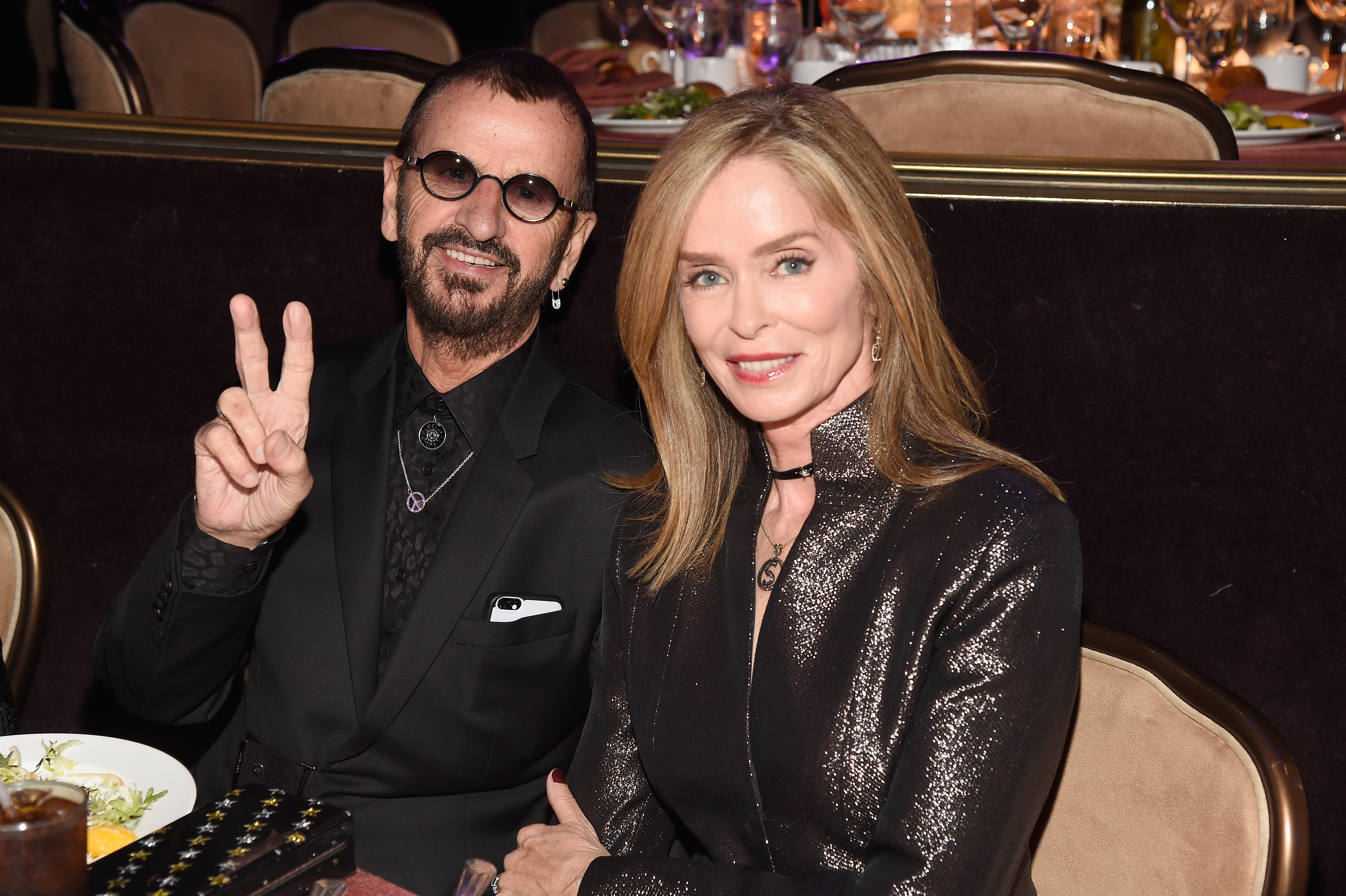 Ringo Starr and his wife at the Pre-Grammy Gala and Salute to Industry Icons Honoring Debra Lee on February 11, 2017, in Los Angeles, California | Source: Getty Images