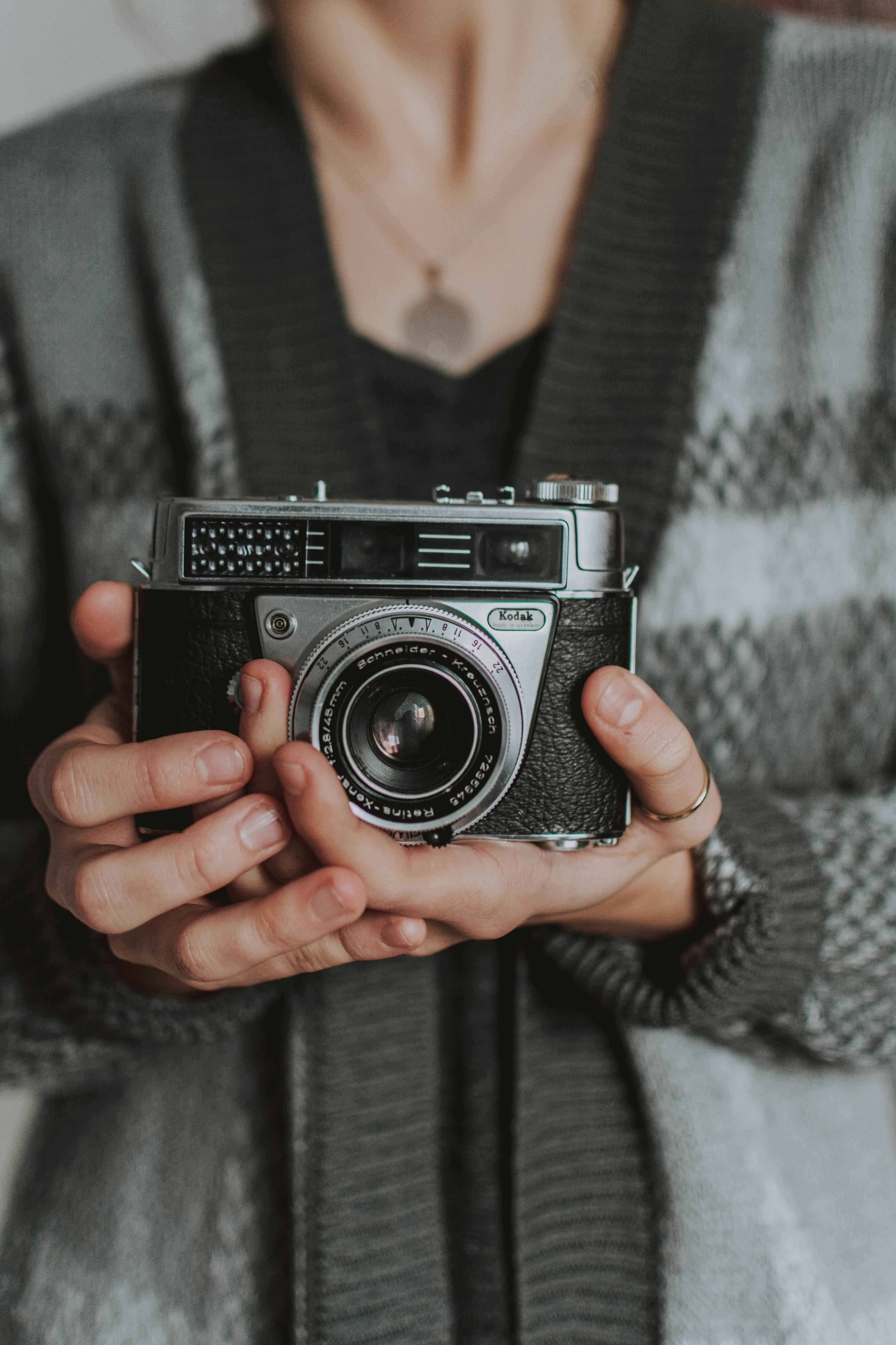 Woman holding an analog camera | Source: Pexels