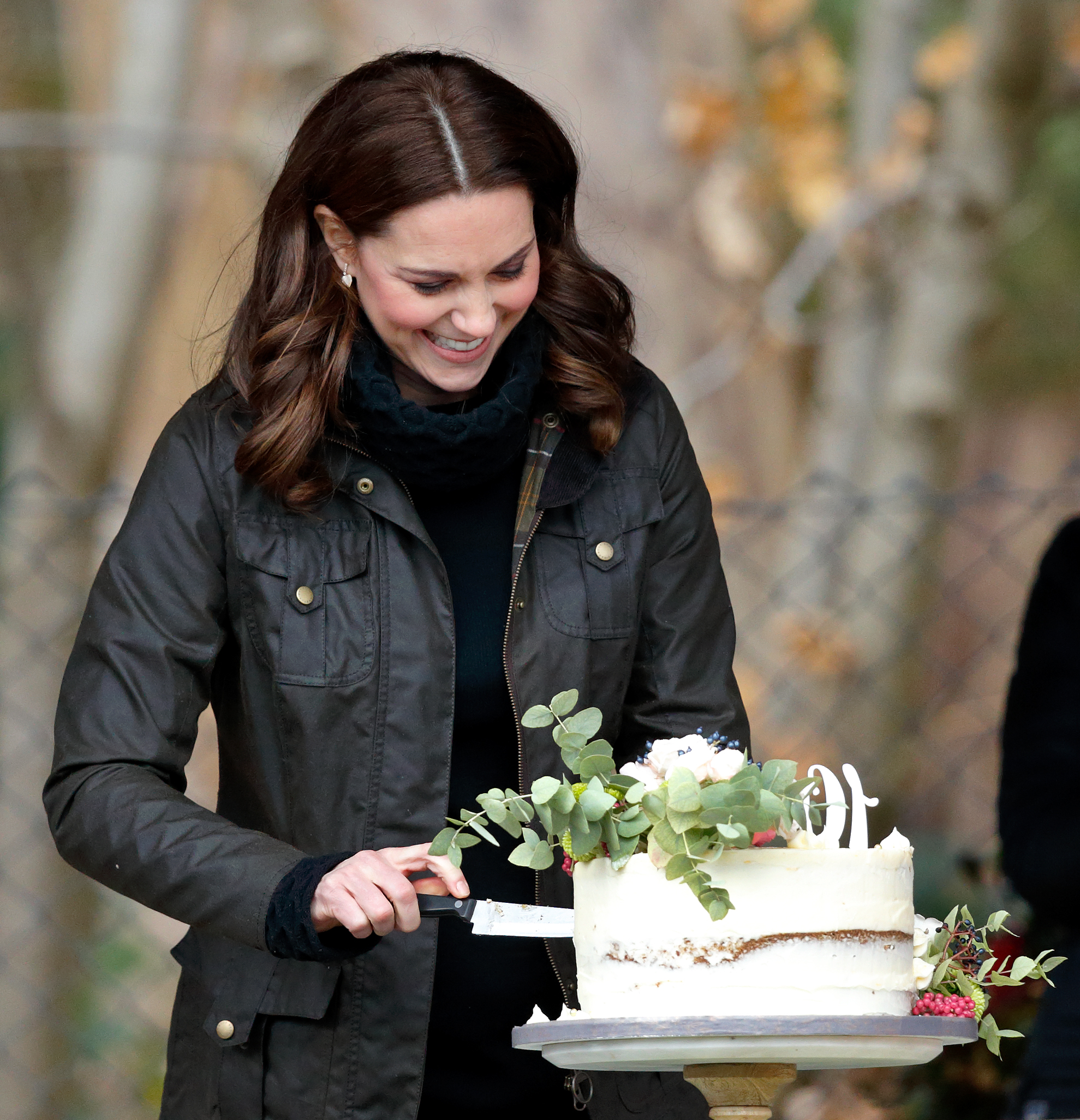 Kate Middleton cutting a cake during her visit to Robin Hood Primary School in London, England on November 29, 2017 | Source: Getty Images