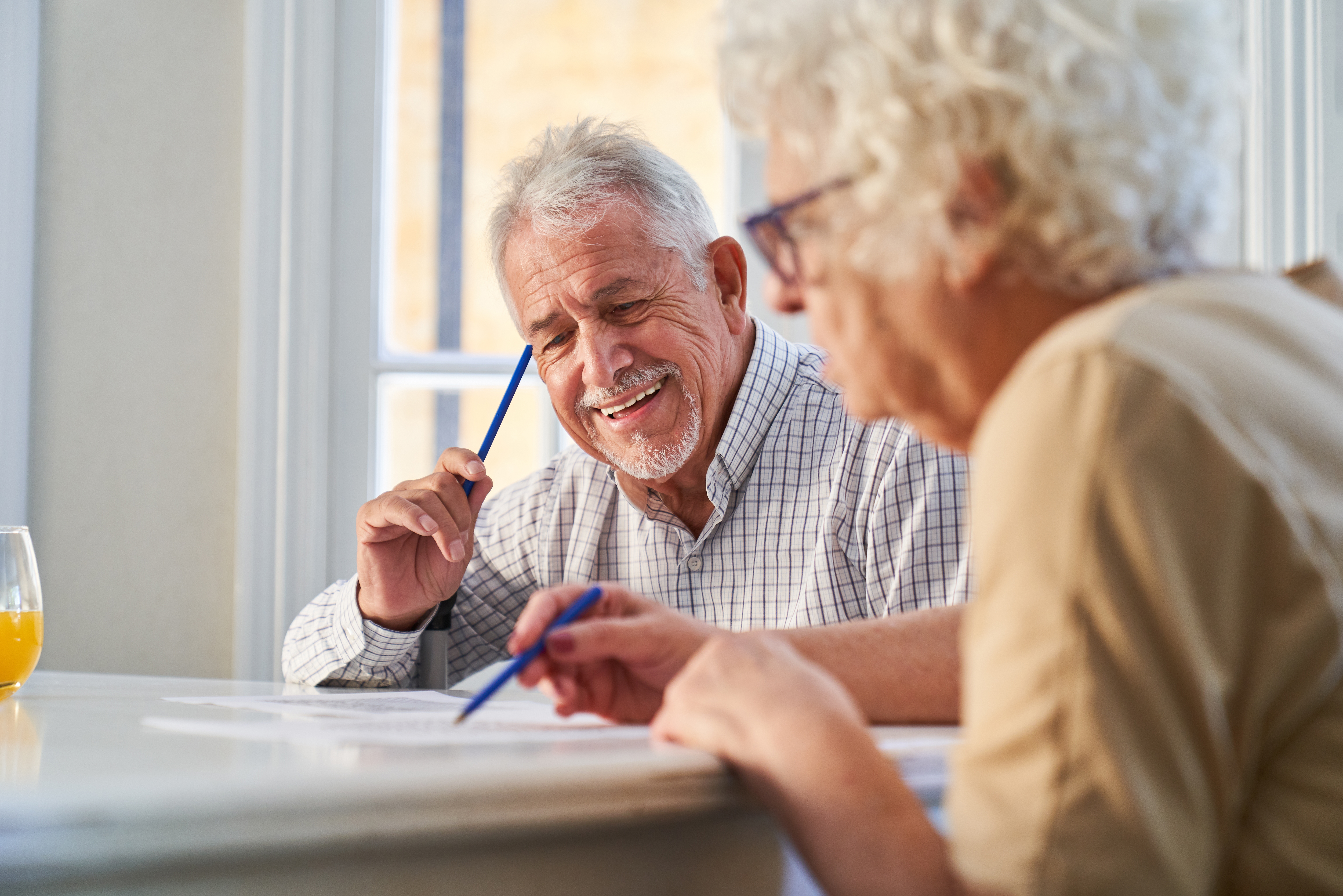 A elderly couple working together on riddles | Source: Shutterstock