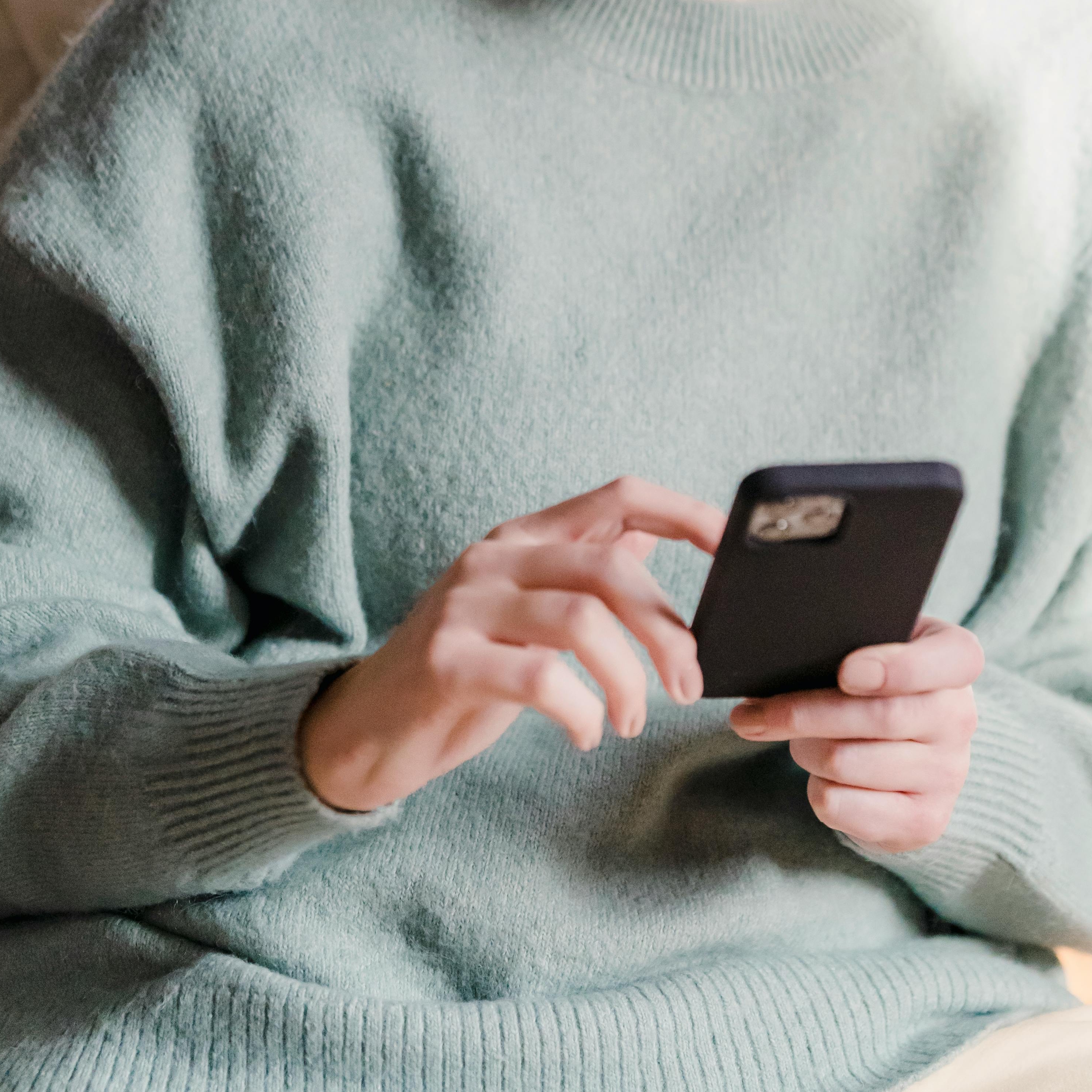 A pair of hands holding a mobile phone | Source: Pexels