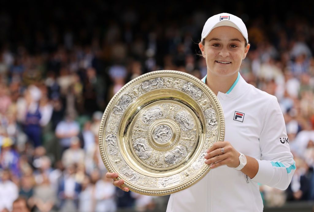 Australian tennis player Ash Barty holding the Venus Rosewater Dish trophy after winning her Wimbledon 2021 Ladies' Singles Final match against Karolina Pliskova at in London, England | Photo: Clive Brunskill/Getty Images