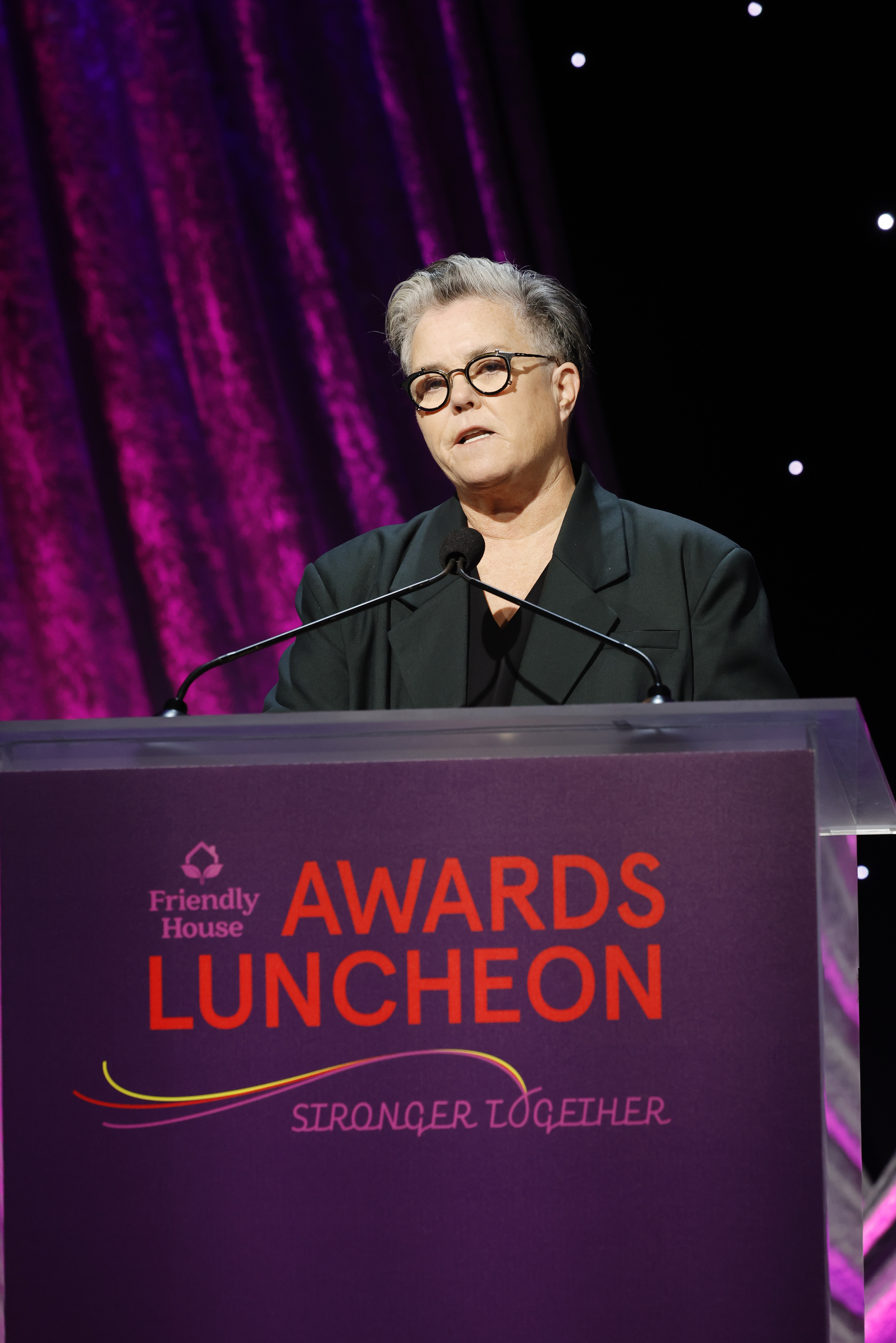 Speaking onstage at the Friendly House Awards Luncheon on October 28, 2023, Rosie O'Donnell wore a serious expression, her tailored jacket and clean-cut hairstyle reinforcing the sharp, composed presence she brought to the podium.
