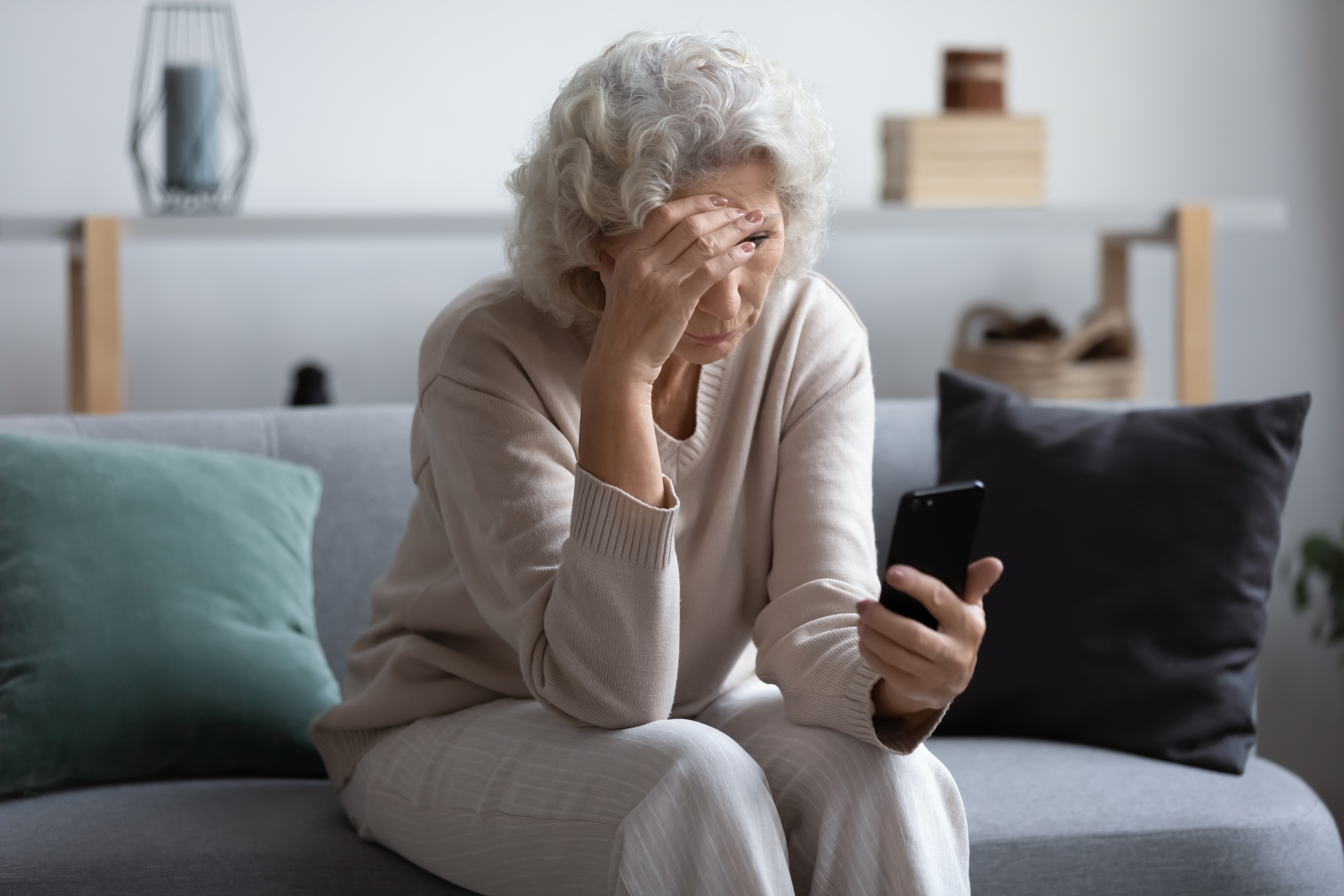 A woman looking stressed while on the phone | Source: Shutterstock