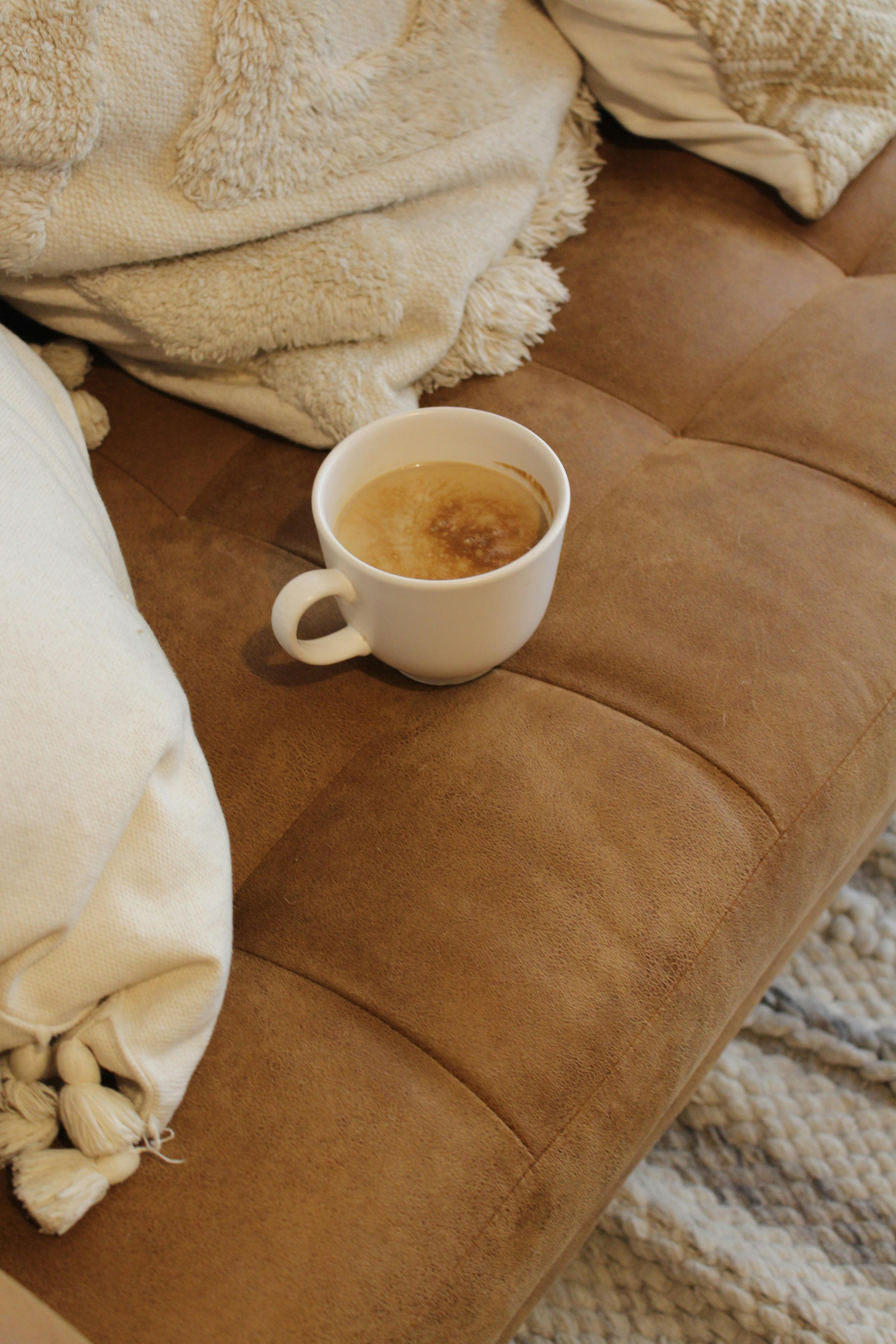 A couch with a cup of coffee on top of it | Source: Pexels