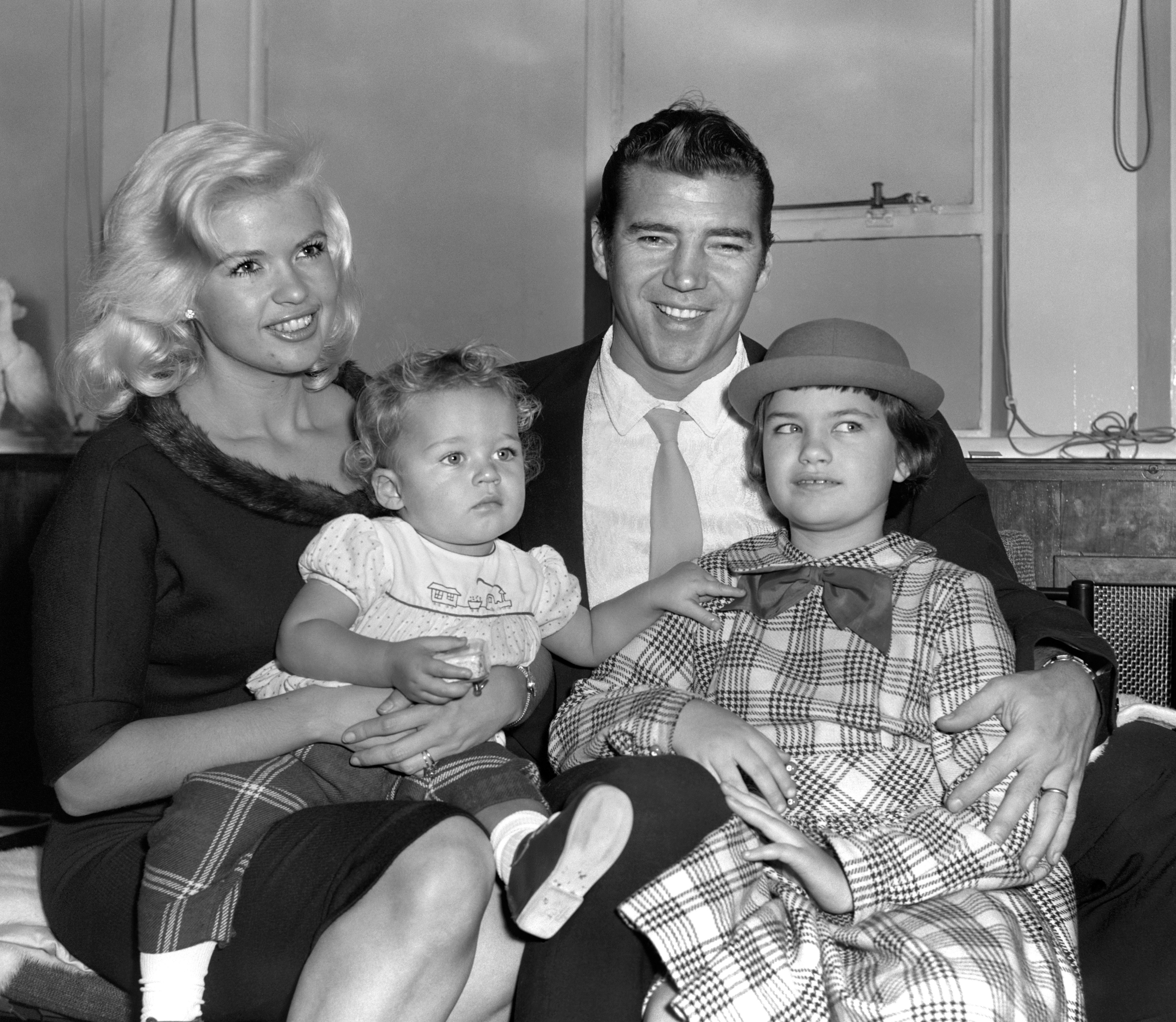 Jayne Mansfield, her husband Mickey Hargitay, her daughter Jayne Marie, 9, and son Miklos, 11 months old, at London Airport on December 16, 1959 | Source: Getty Images