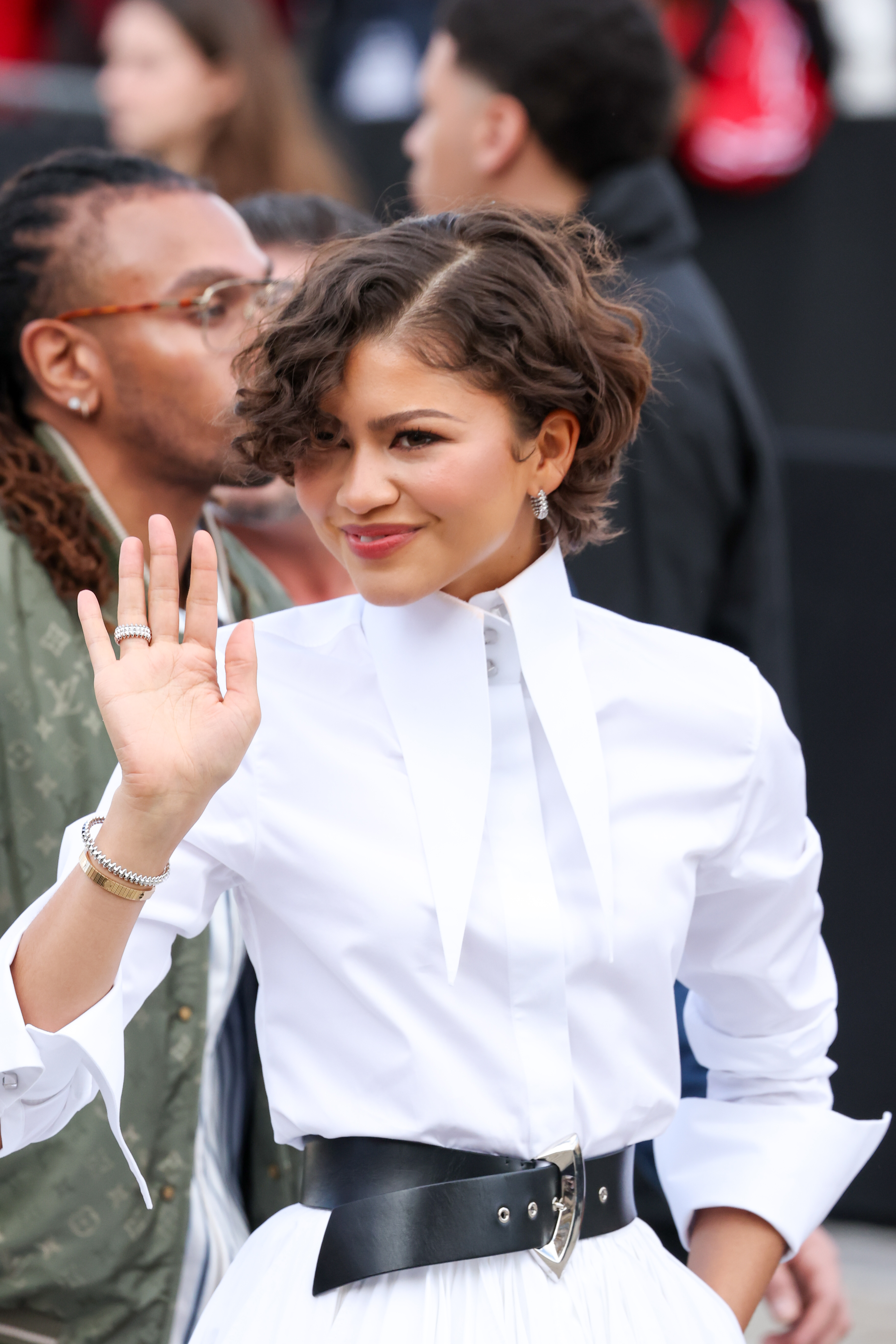Zendaya waves to the crowd at Louis Vuitton Womenswear Fall/Winter show in Paris on March 10, 2026. | Source: Getty Images