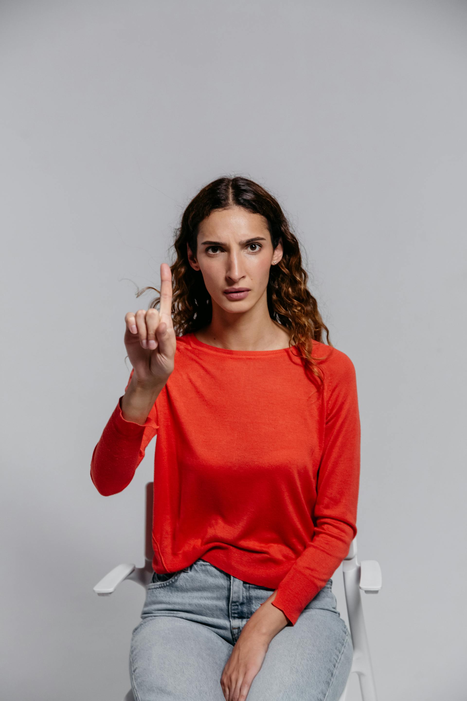 A woman gesturing with one finger | Source: Pexels