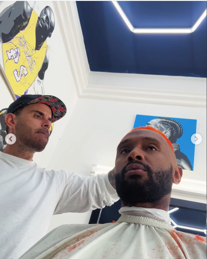 A photo of Brian McKnight Jr., having a hair cut, from a post dated November 6, 2025. | Source: Instagram/brianmcknightjr