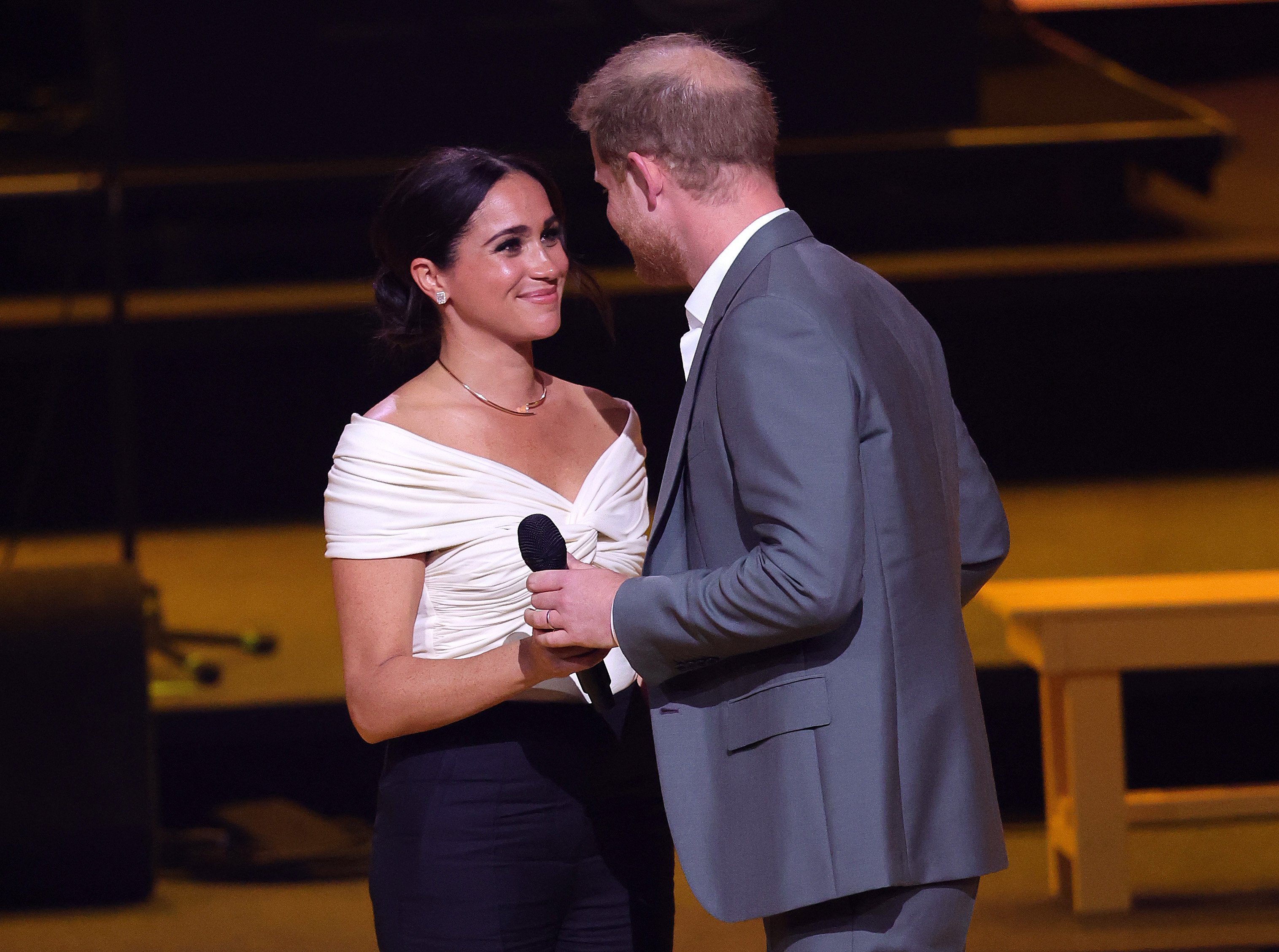 Prince Harry, Duke of Sussex and Meghan, Duchess of Sussex on stage during the Invictus Games The Hague 2020 Opening Ceremony at Zuiderpark on April 16, 2022 in The Hague, Netherlands. | Source: Getty Images