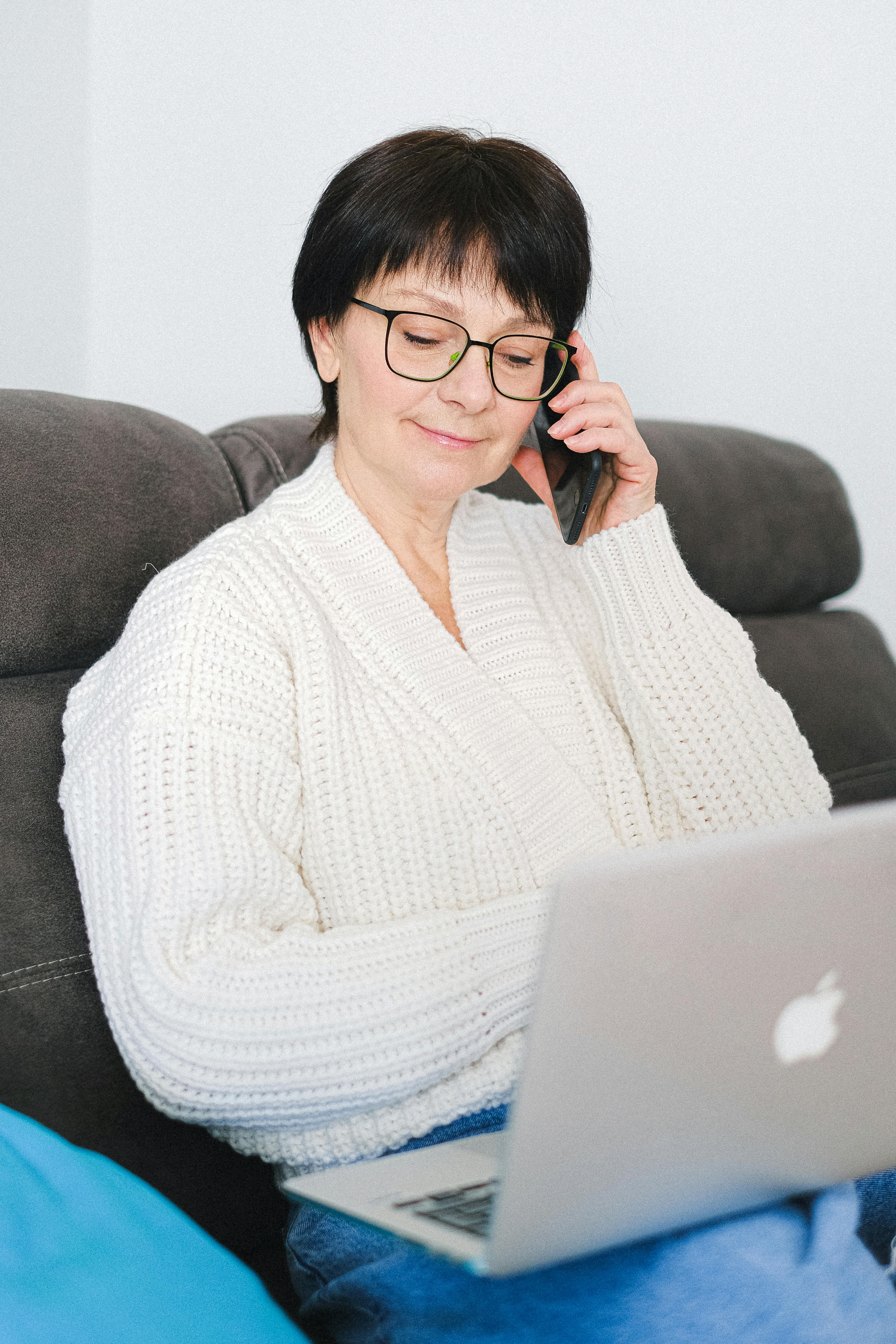 A woman smiling and talking on her phone | Source: Pexels