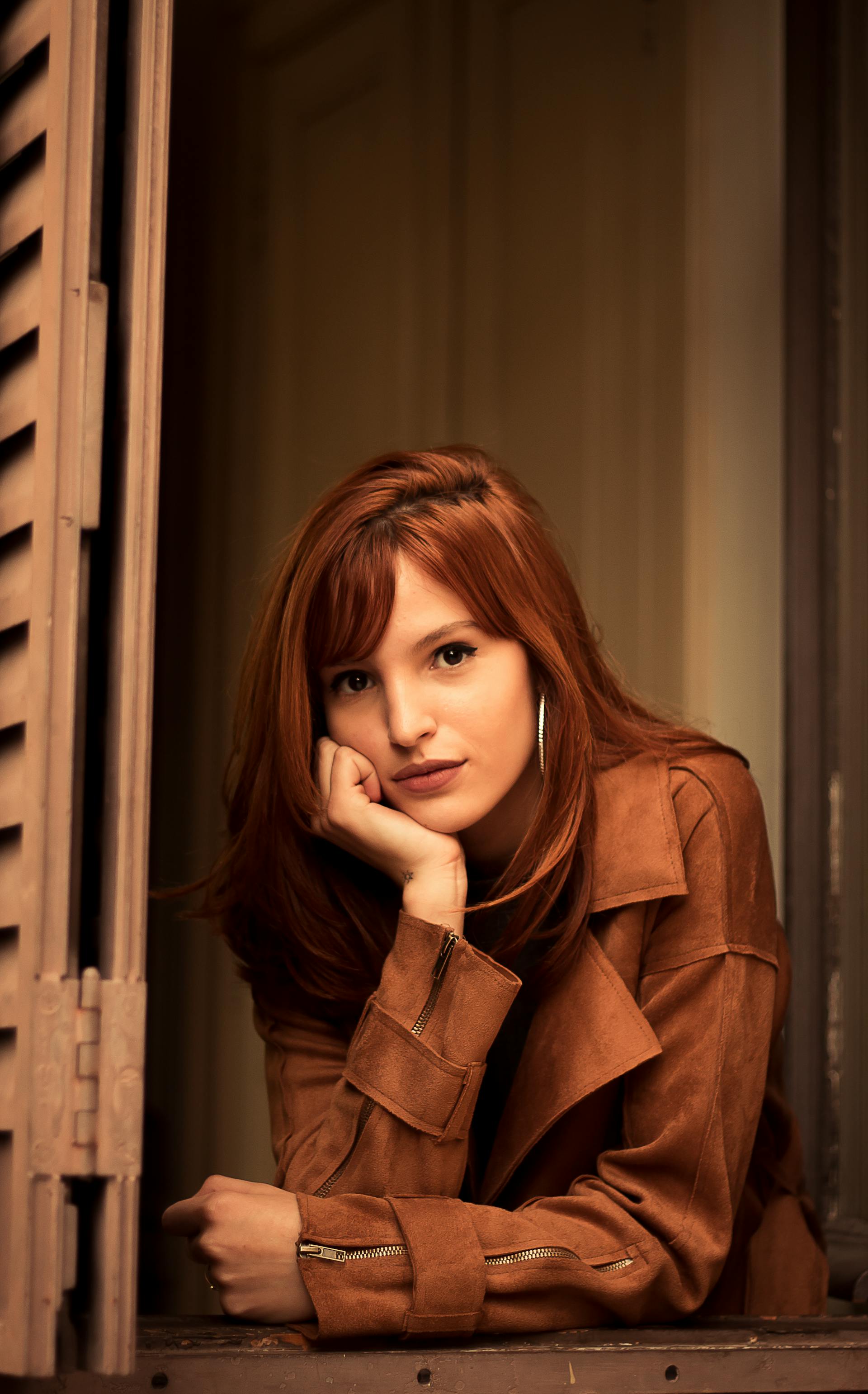 A woman at a window | Source: Pexels