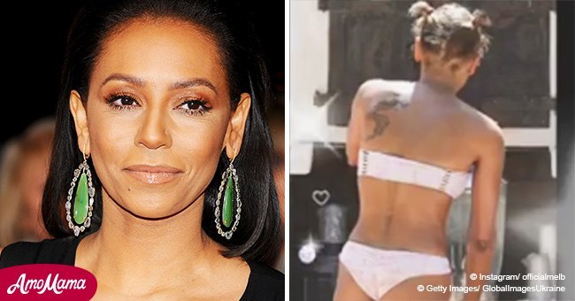 An unrecognizable Mel B flaunts her stunning body in a pink bikini and heels