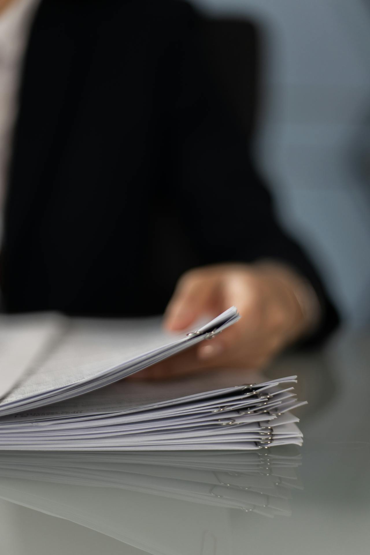 A person holding paperwork | Source: Pexels
