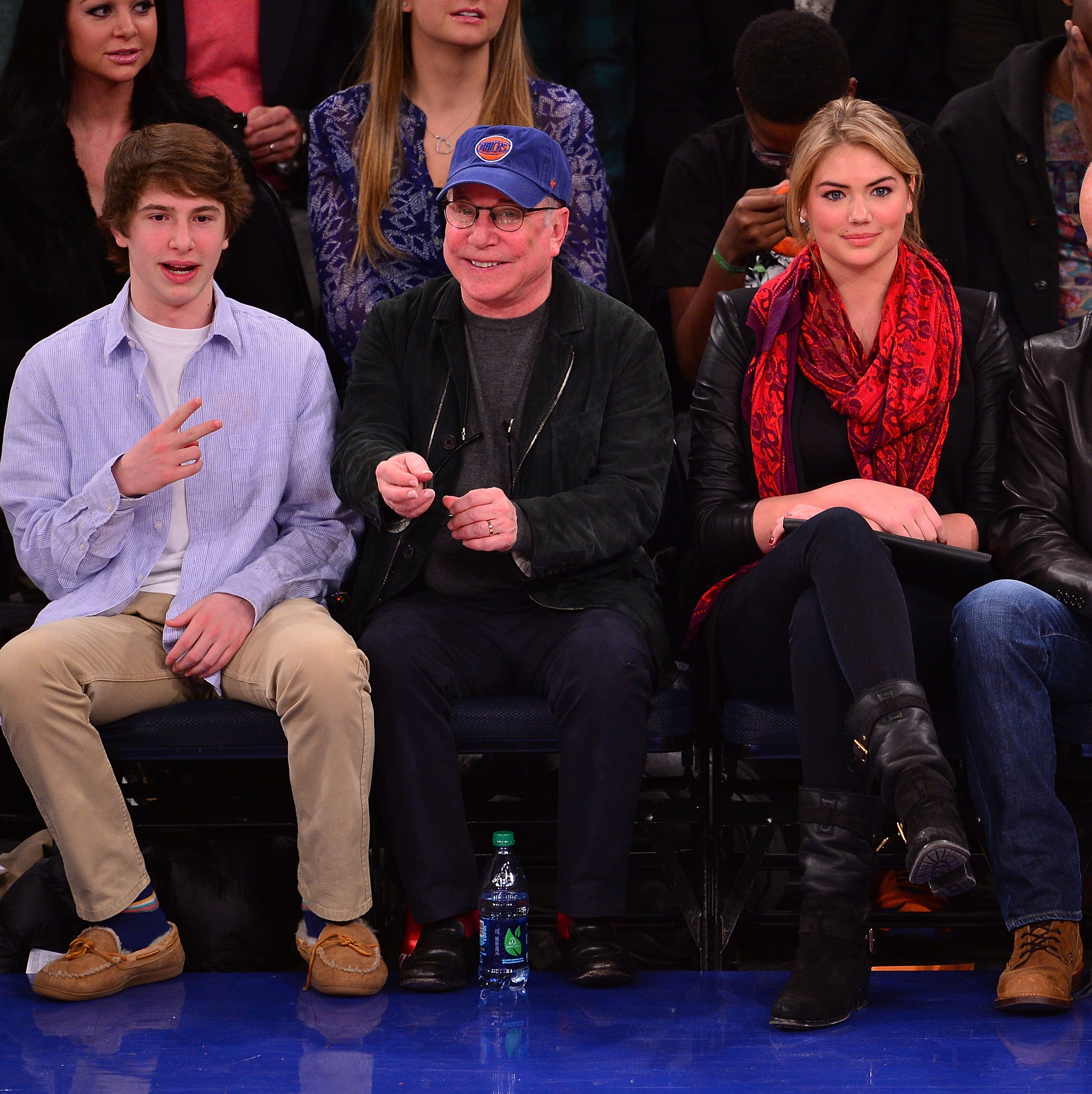 Adrian edward Simona sitting courtside with his father and Kate Upton at a Miami Heat vs New York Knicks game at Madison Square Garden on January 9, 2014, in New York City | Source: Getty Images