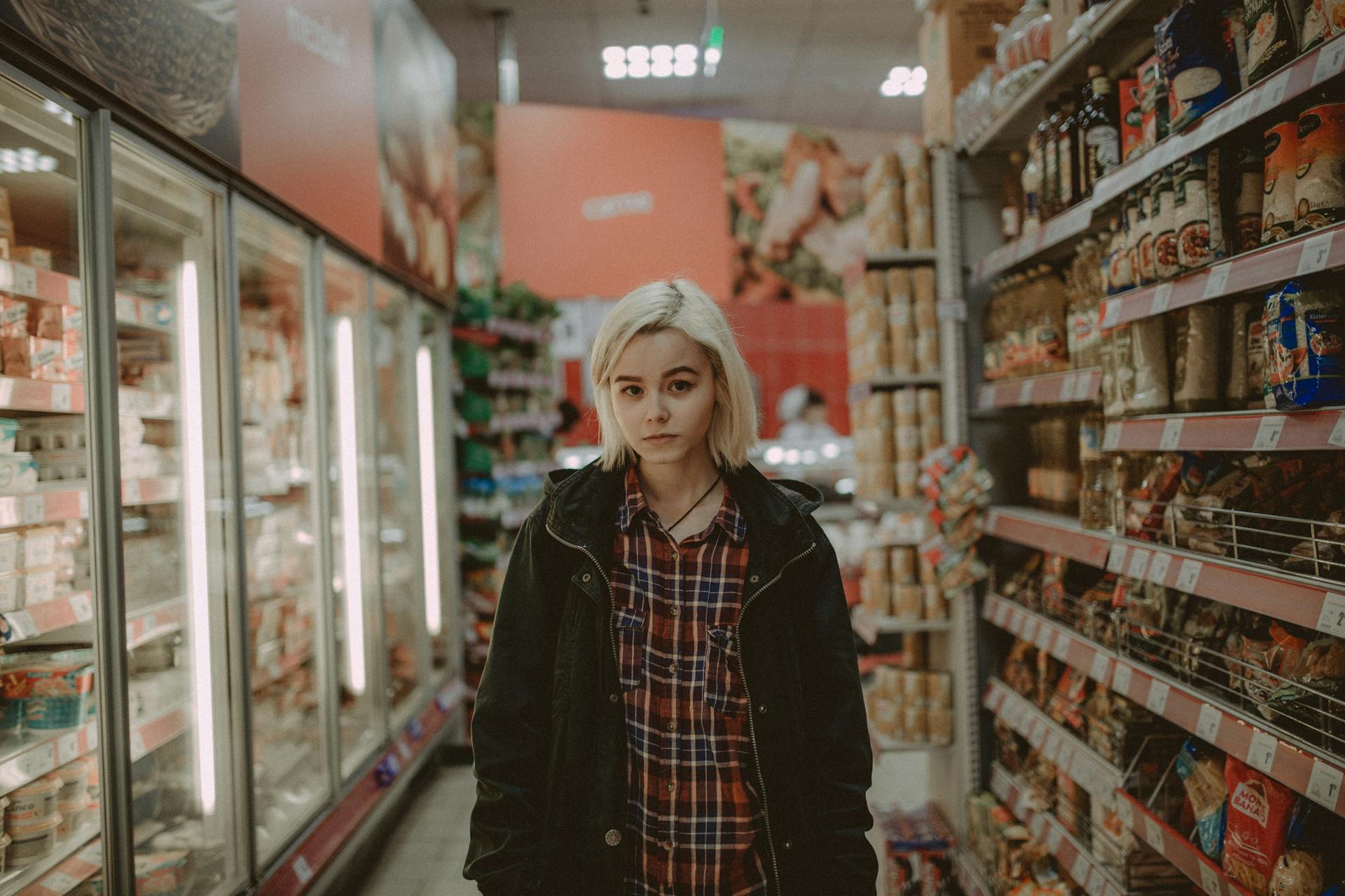 A young woman standing in a grocery store | Source: Pexels