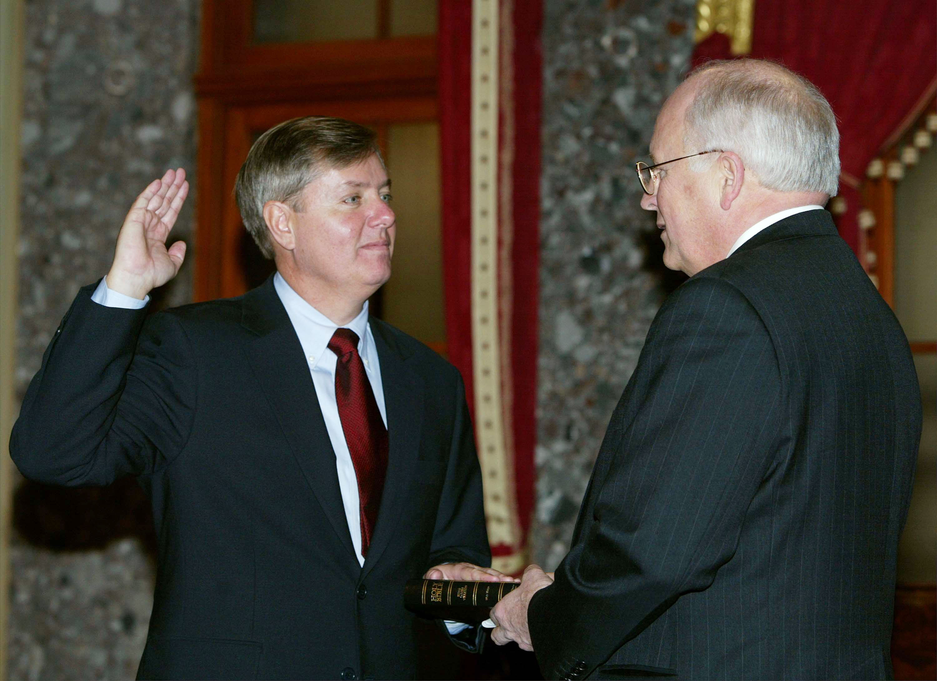 With his right hand raised, Lindsey Graham takes the oath of office during a ceremonial swearing-in on Capitol Hill, marking the beginning of a new chapter in the Senate. The moment signaled his transition from the House of Representatives to a role that would shape the rest of his political career. | Source: Getty Images