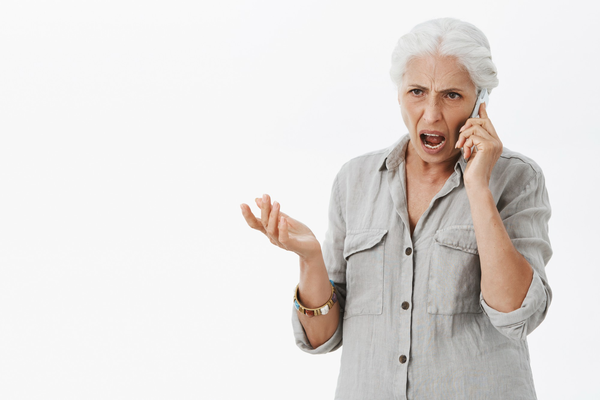 An upset woman talking on the phone | Source: Freepik