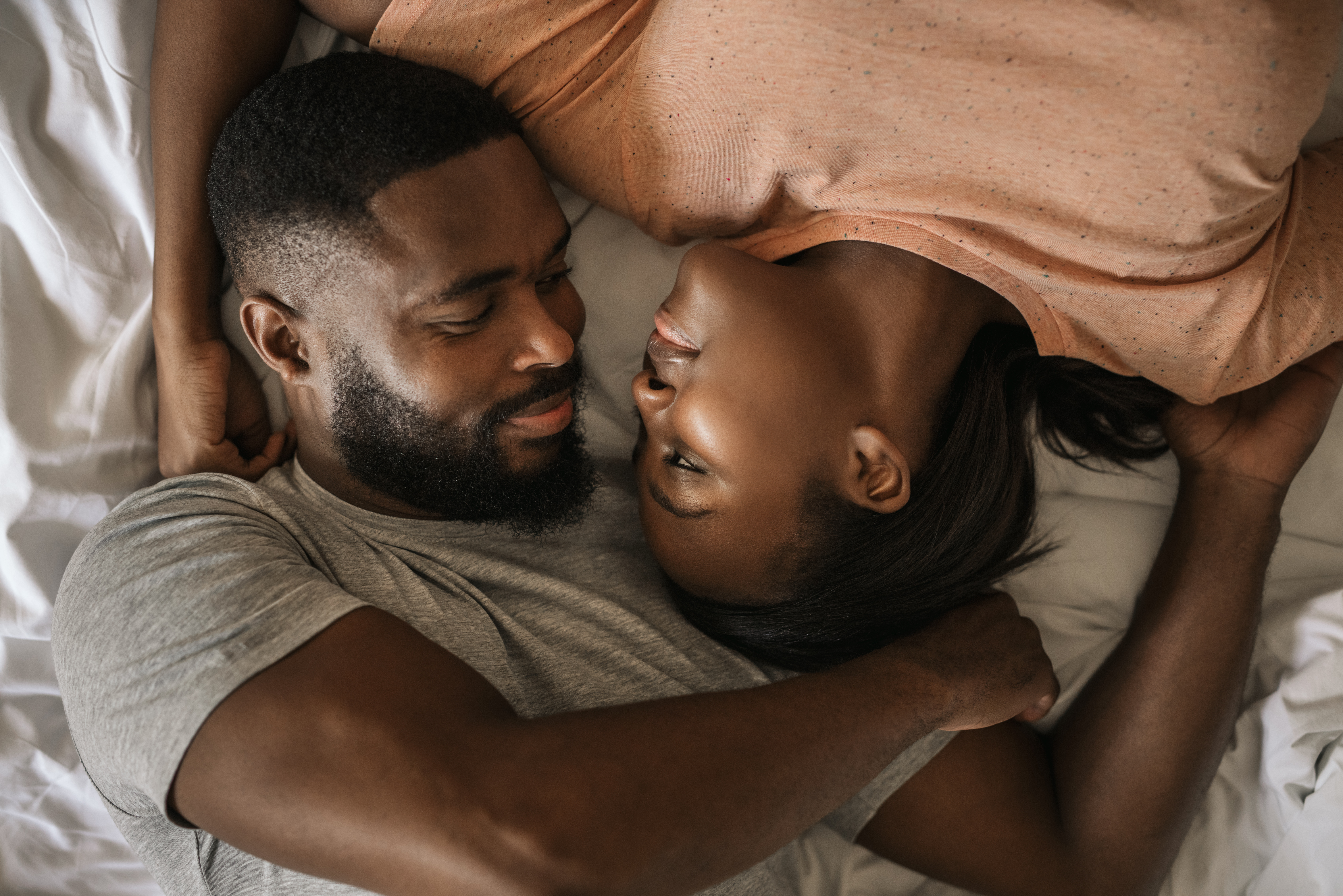 A young couple spending quality in bed | Source: Shutterstock