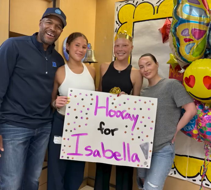 Michael Strahan and Sophia proudly celebrate Isabella’s milestone moment with a "Hooray for Isabella" sign, joined by Kayla Quick, as posted on June 15, 2024 | Source: YouTube/IsabellaStrahan