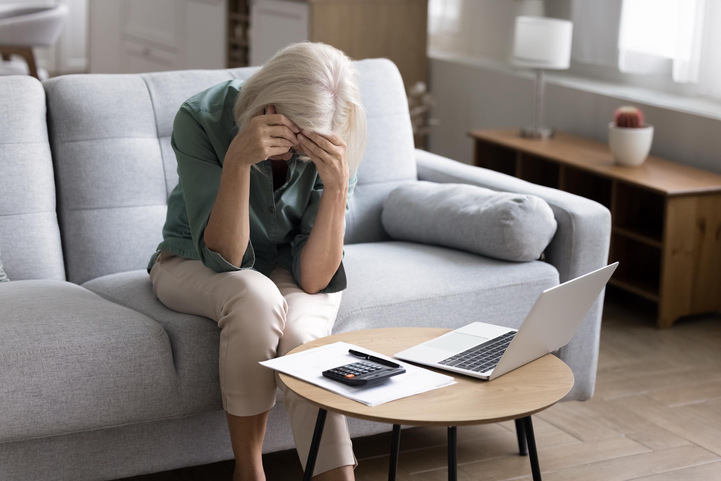 Woman feeling overwhelmed while managing her budget | Source: Shutterstock