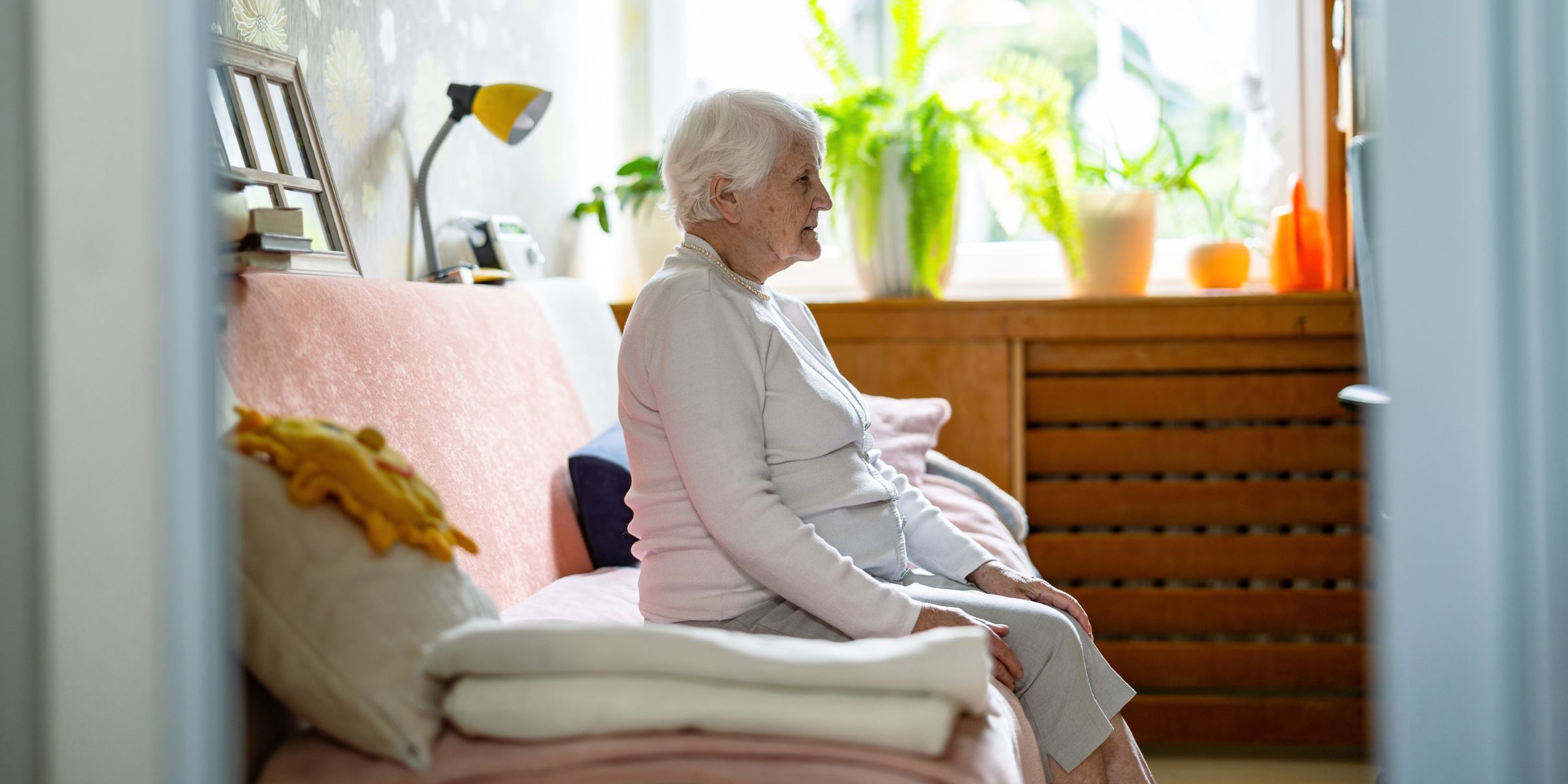 A sad woman sitting alone in her room | Source: Shutterstock