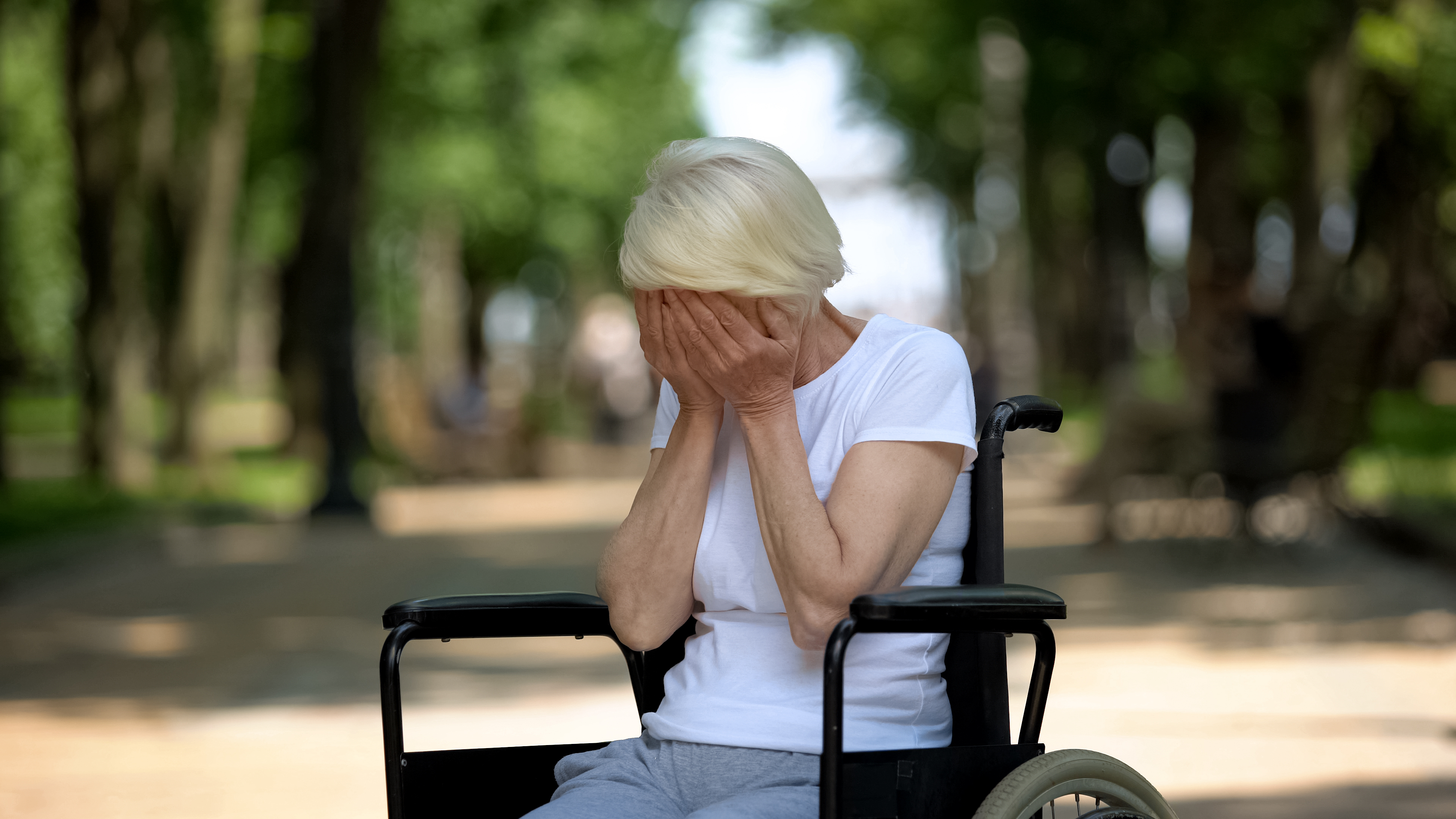 An older woman sitting on a wheelchair | Source: Shutterstock