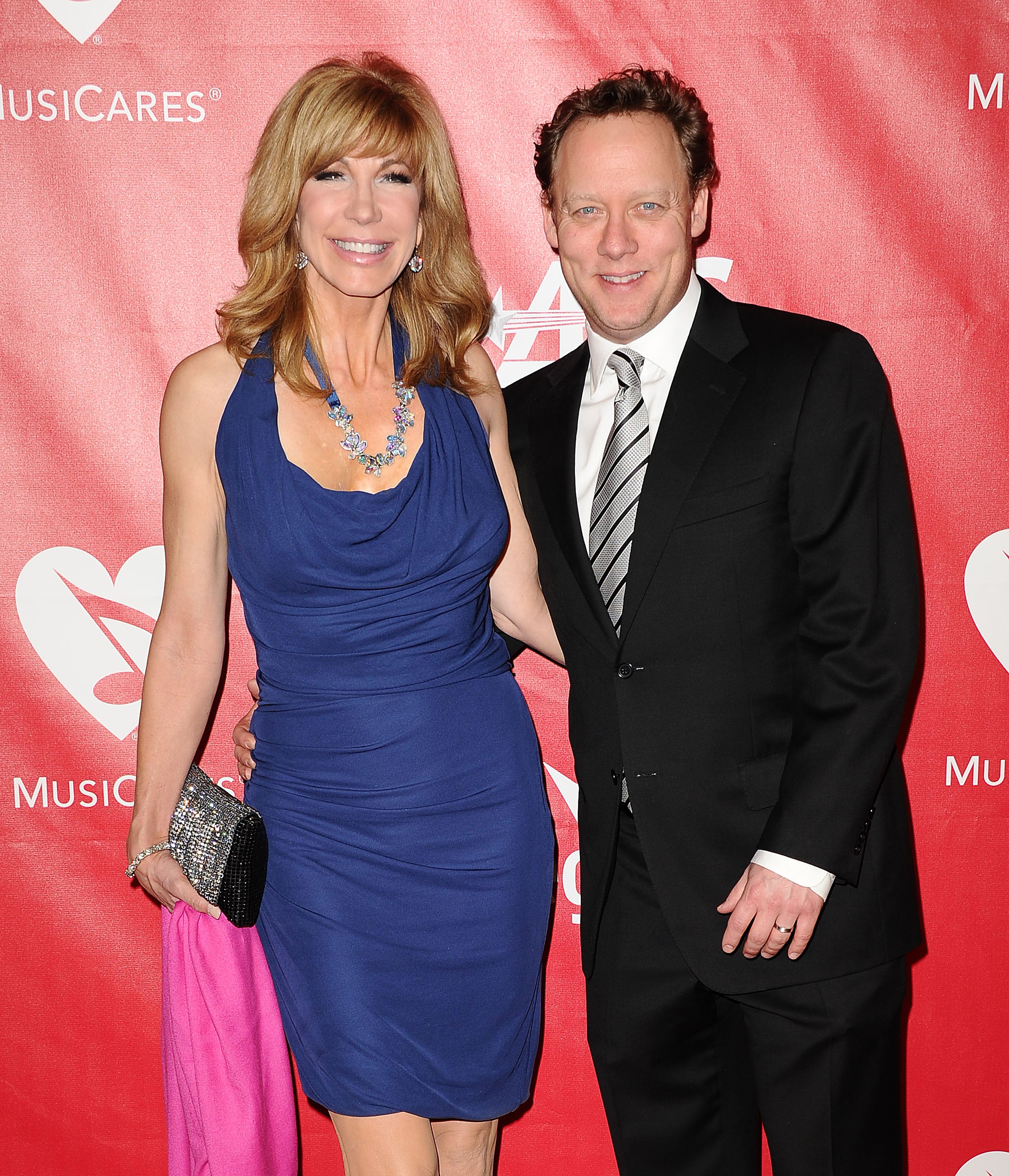Leeza Gibbons and husband Steven Fenton pose at the 2014 MusiCares Person of the Year event, honoring Carole King, on January 24, 2014, in Los Angeles | Source: Getty Images