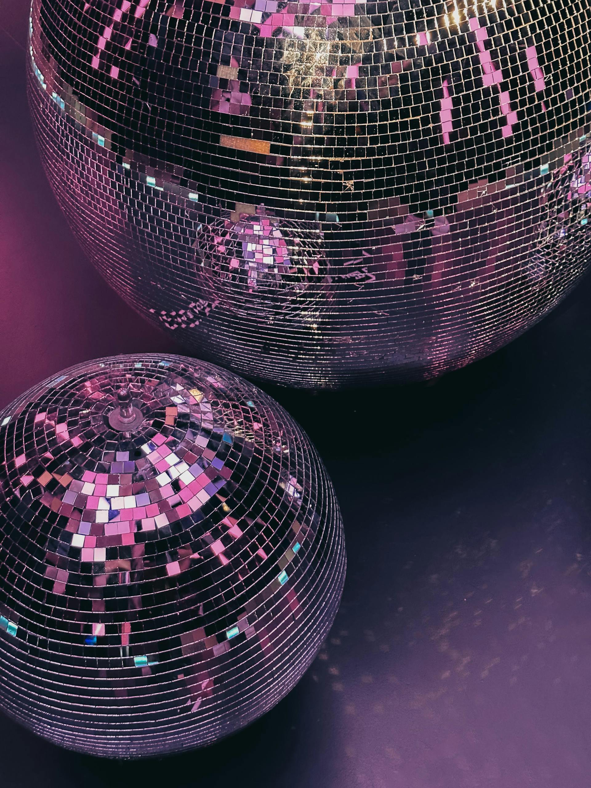 A close-up of disco balls in purple lighting | Source: Pexels