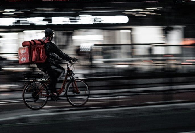 Delivery man on his bike | Source: Unsplash