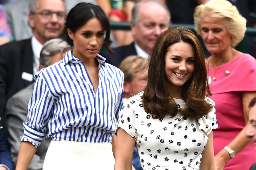 Meghan Markle and Kate find their seats as they attend the Wimbledon Lawn Tennis Championships on July 14, 2018 in London, England | Source: Clive Mason/Getty Images