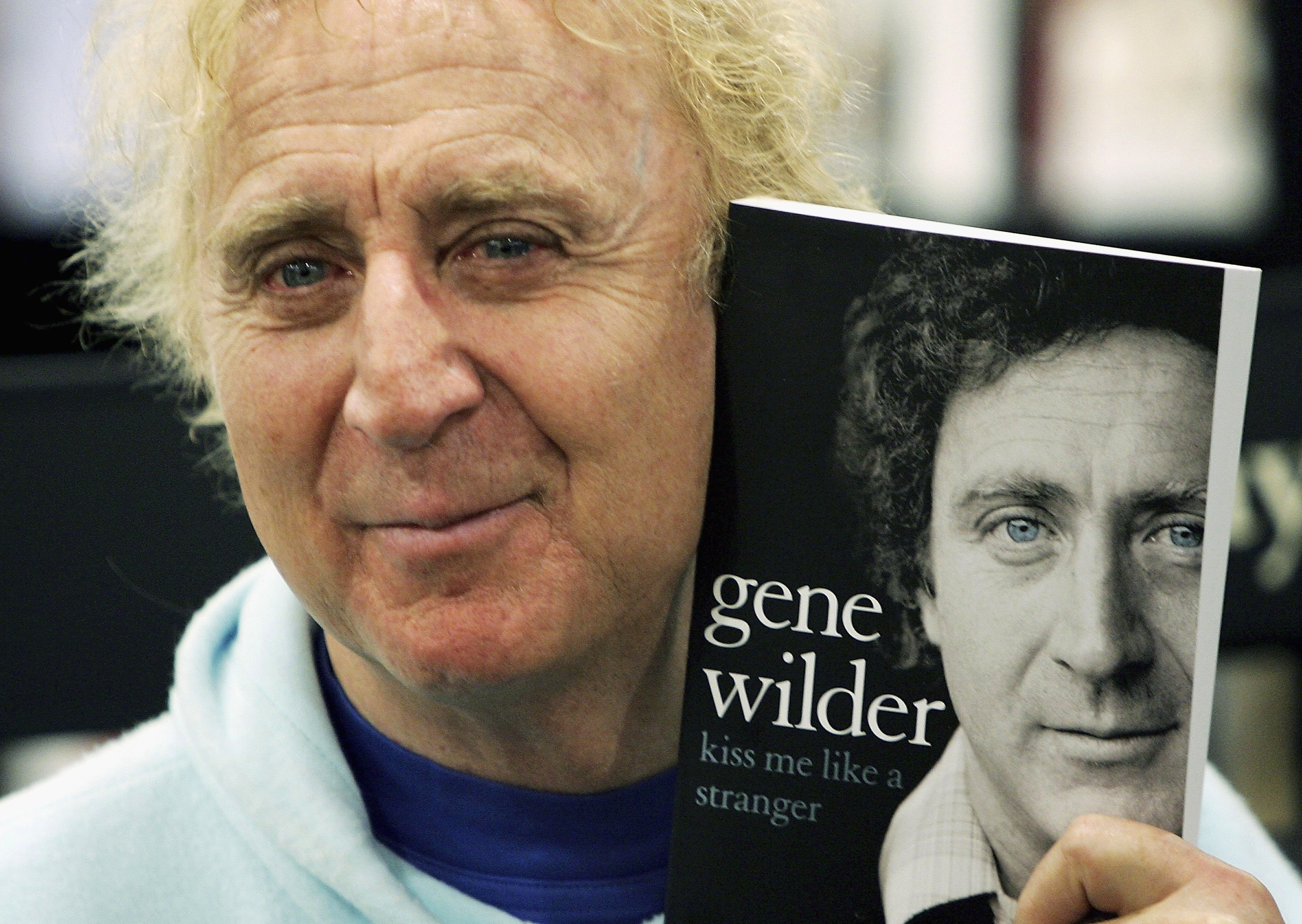 Gene Wilder poses with his memoir "Kiss Me Like A Stranger" at Waterstones Bookshop on June 7, 2005, in London, England. | Source: Getty Images