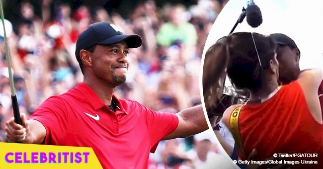 Tiger Woods celebrates his historic comeback victory with a kiss from girlfriend