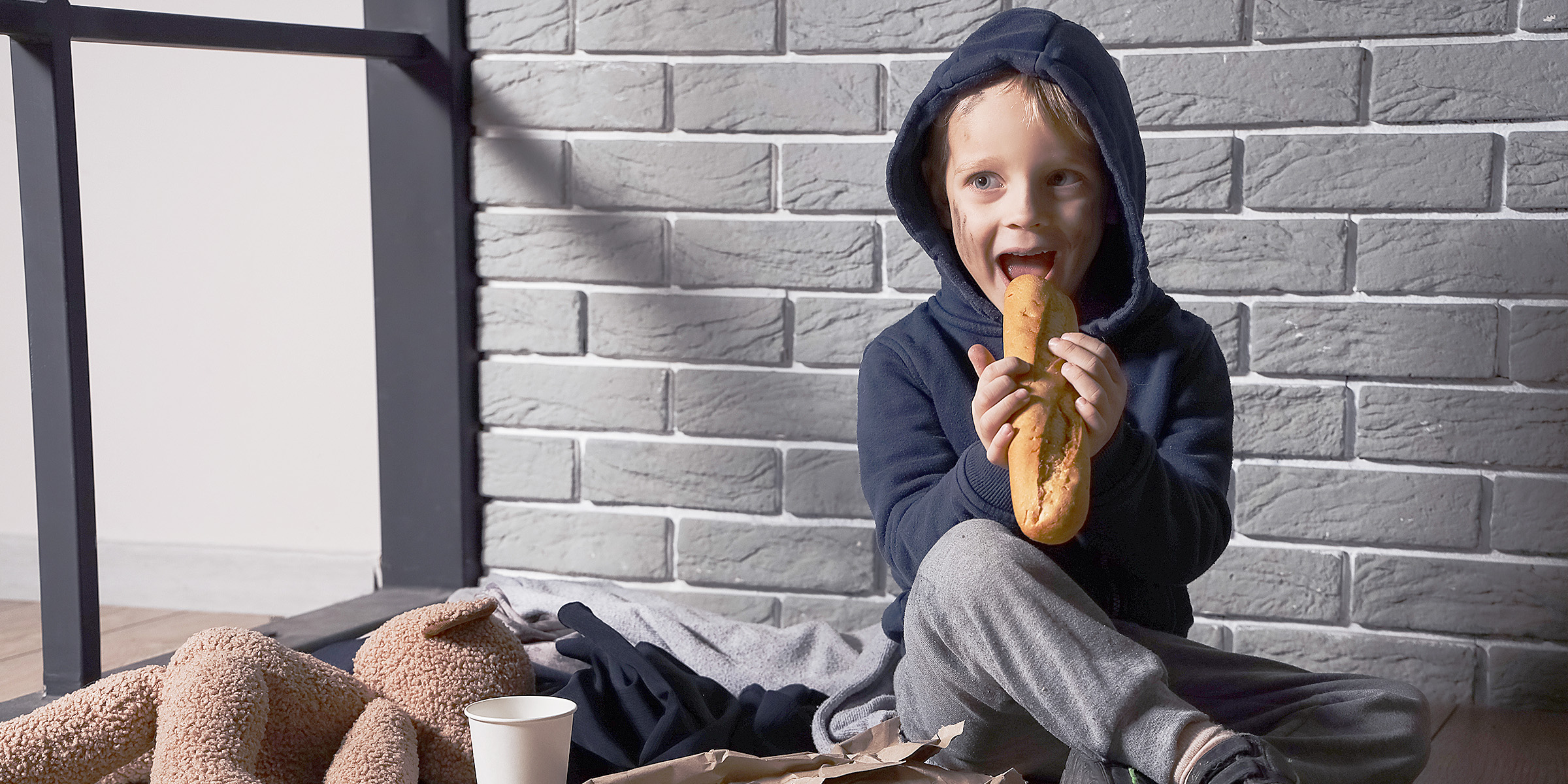 A little boy eating bread | Source: Shutterstock
