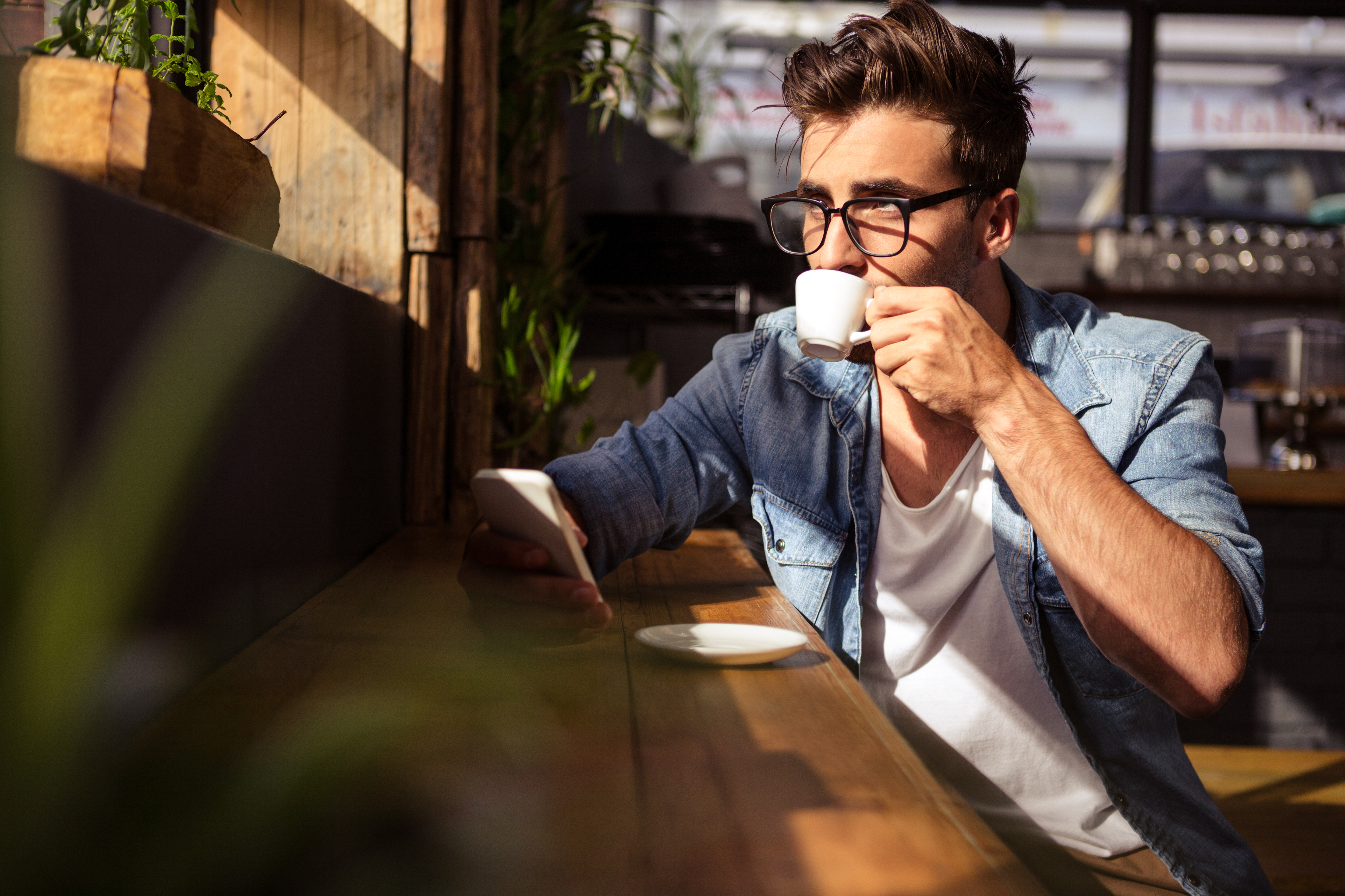 Man drinking a cup of coffee in the cafe | Source: Shutterstock