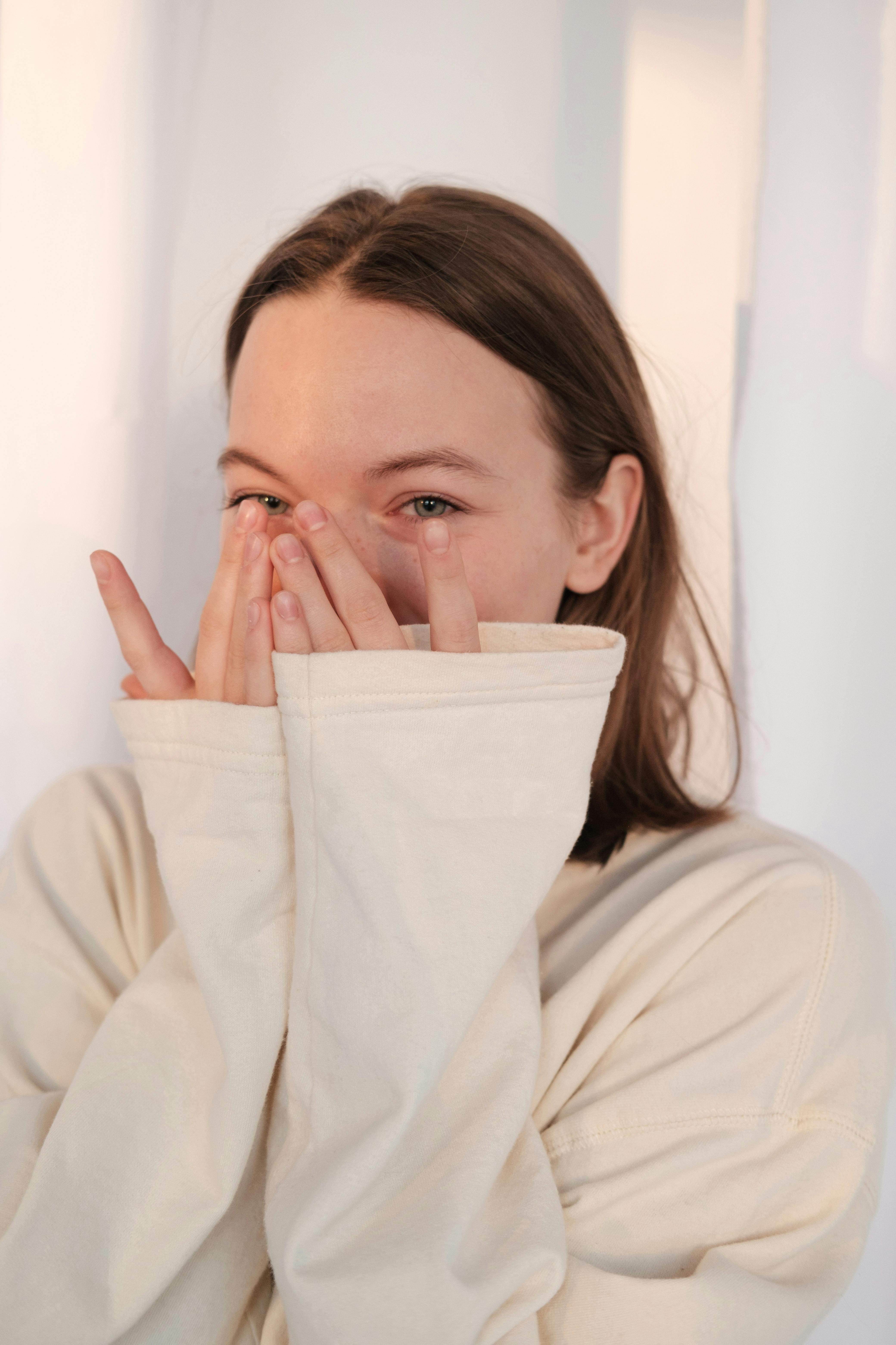 An excited woman covering her face with her hands | Source: Pexels