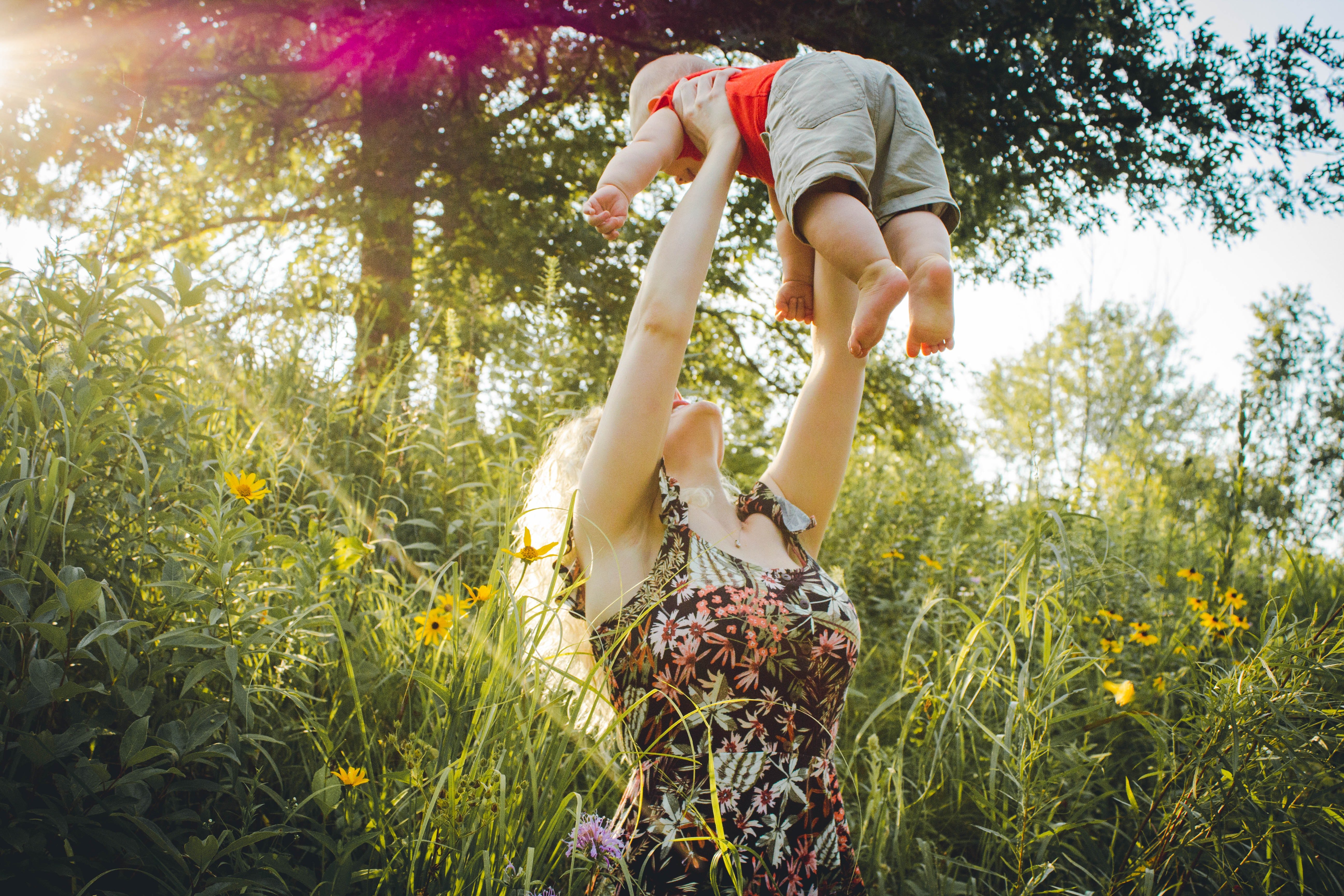 Eine Mutter, die ihr Baby hochhebt. | Quelle: Pexels