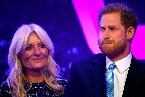 Prince Harry, Duke of Sussex reacts next to television presenter Gaby Roslin as he delivers a speech during the WellChild Awards | Photo: Getty Images