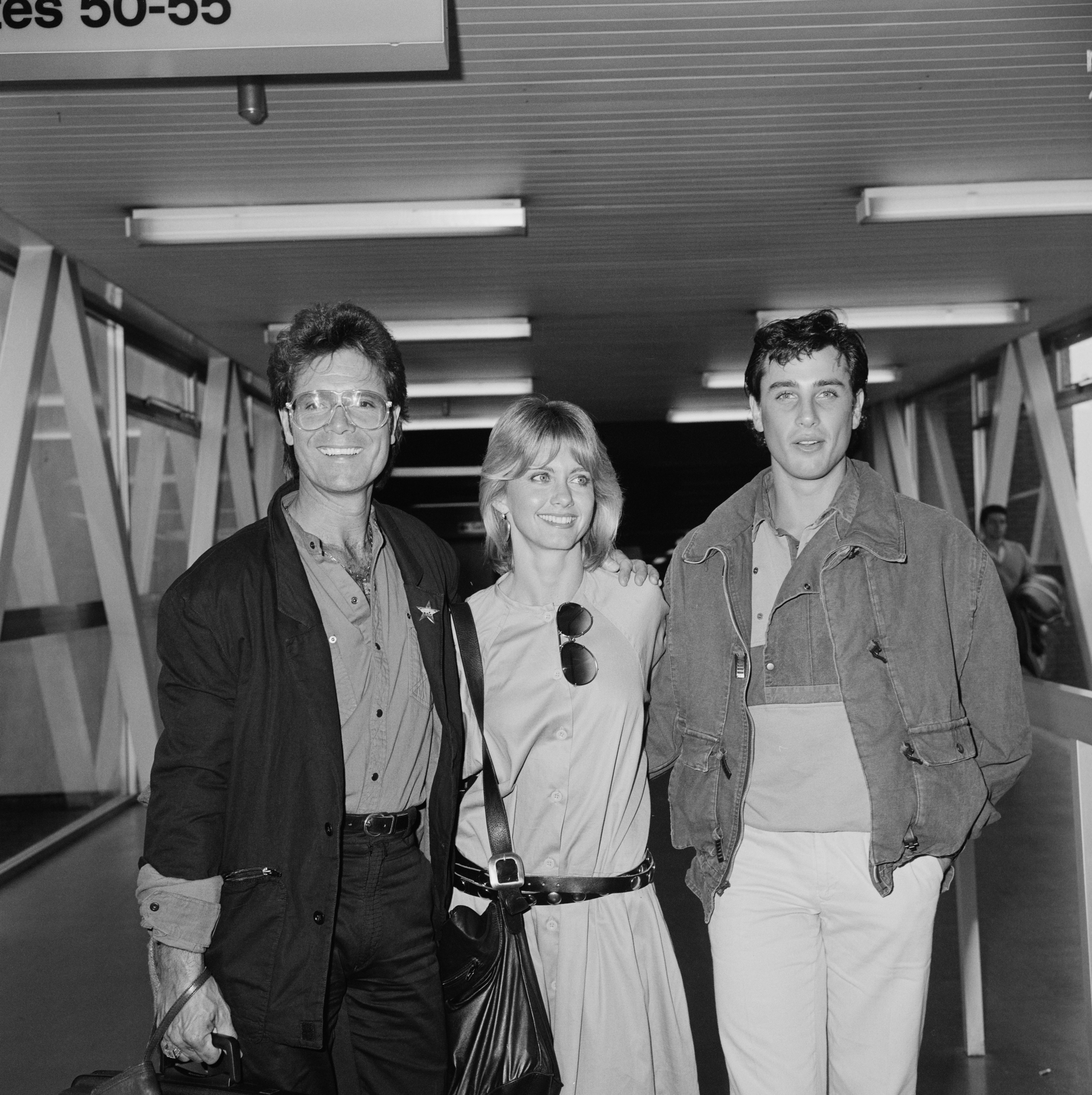 Cliff Richard, Olivia Newton-John and Matt Lattanzi at Heathrow Airport in London |  Source: Getty Images