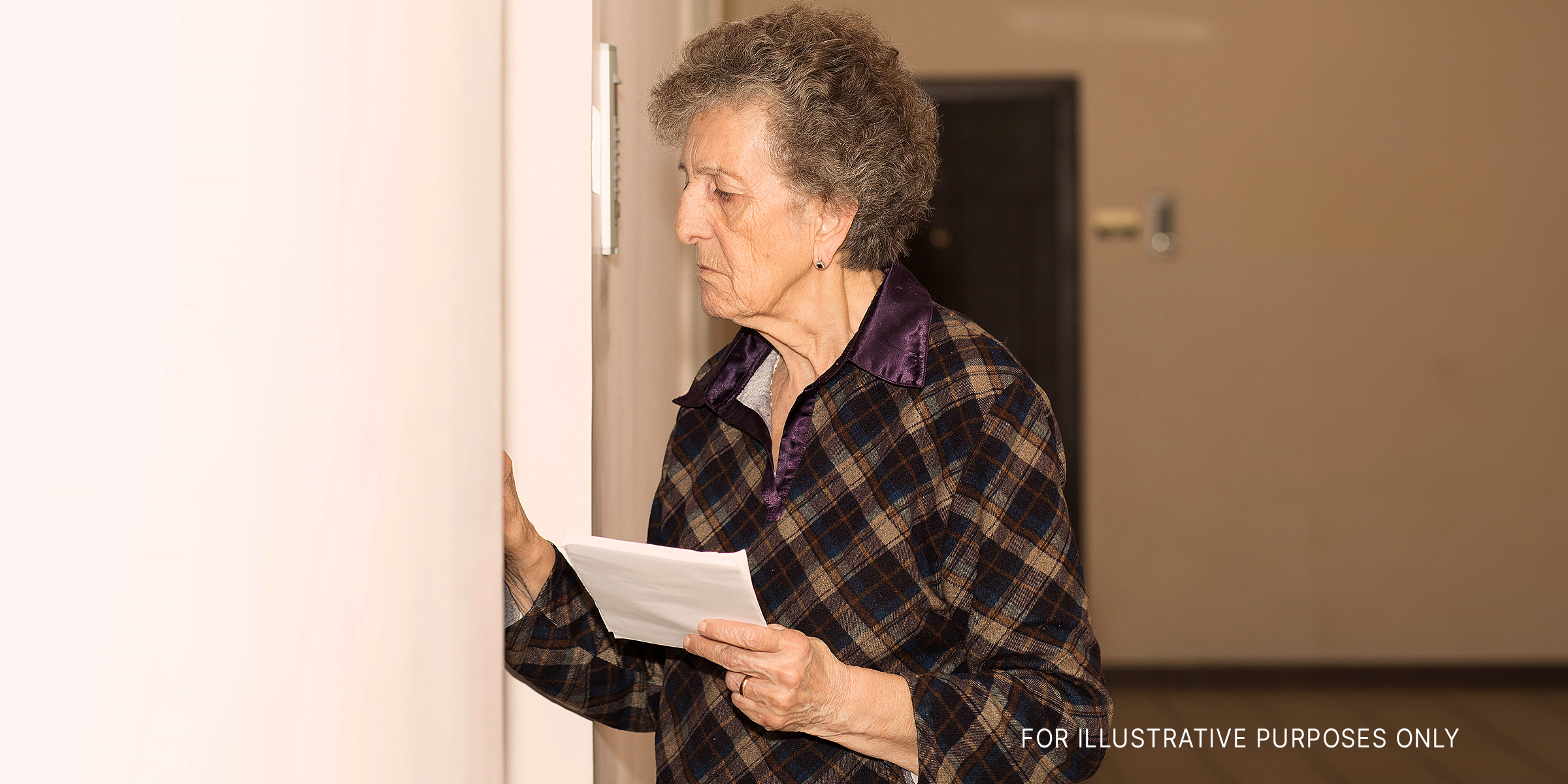 A woman standing outside a door | Source: Shutterstock
