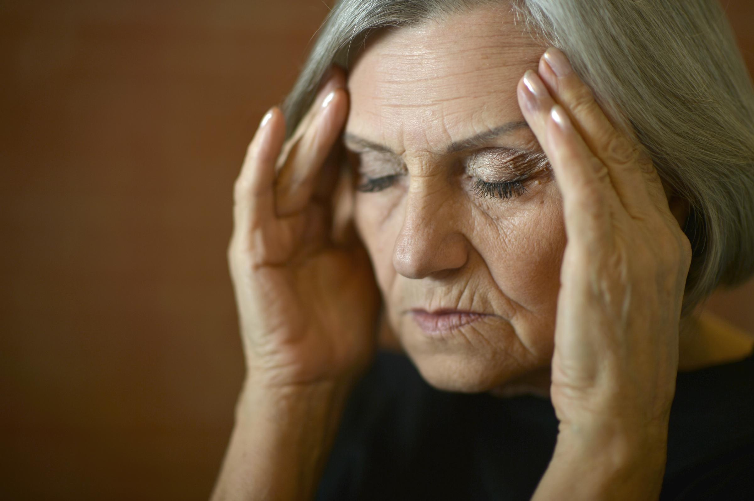 Woman rubbing her temples | Source: Shutterstock