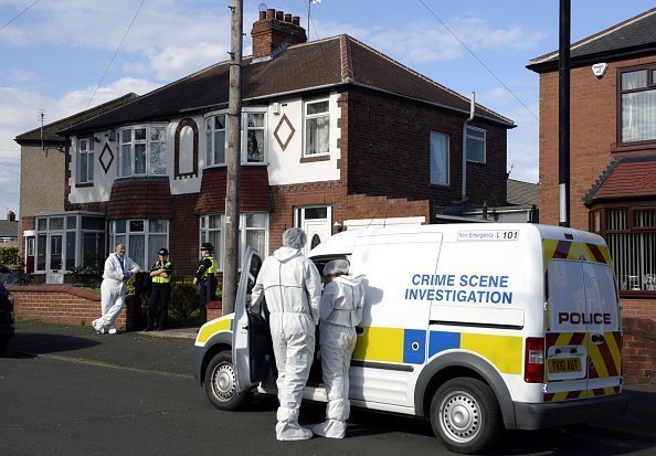 Police and forensics officers outside a house, which is being searched in connection with the disappearance of Claudia Lawrence | Photo: Getty Images