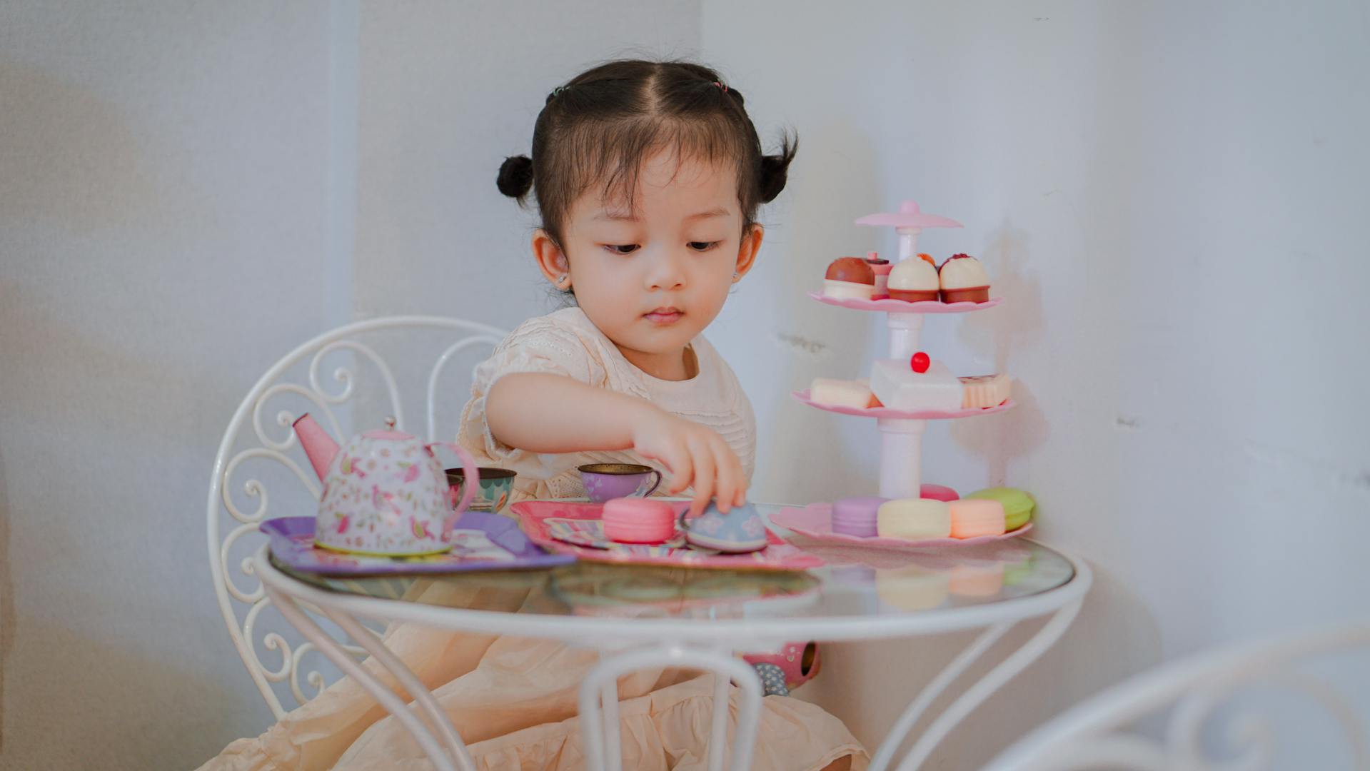 Little girl with a toy tea set | Source: Pexels