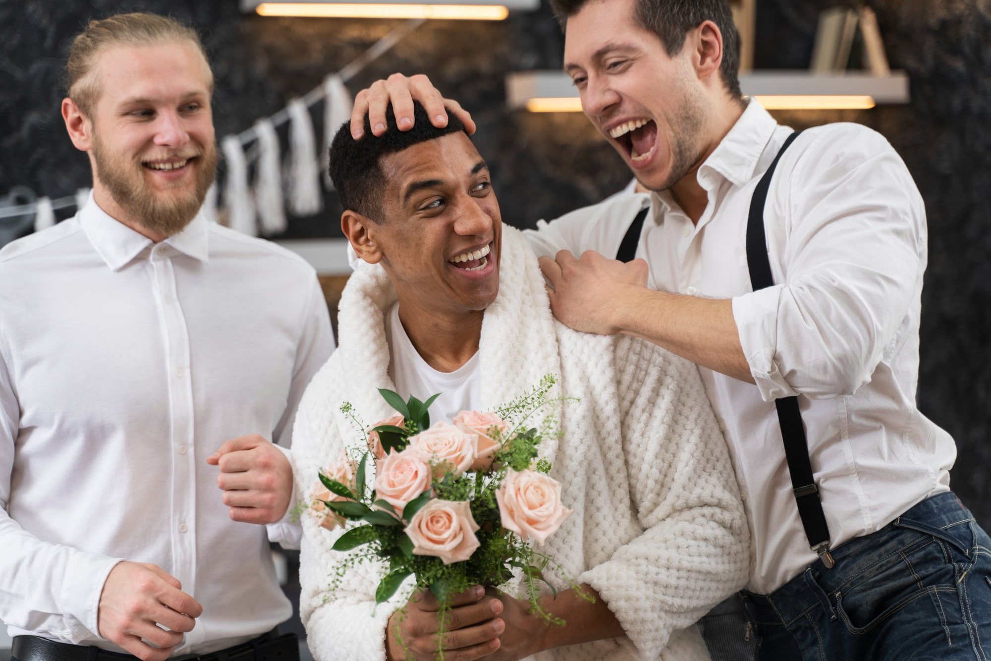 A best man and groomsman celebrating the groom | Source: Freepik