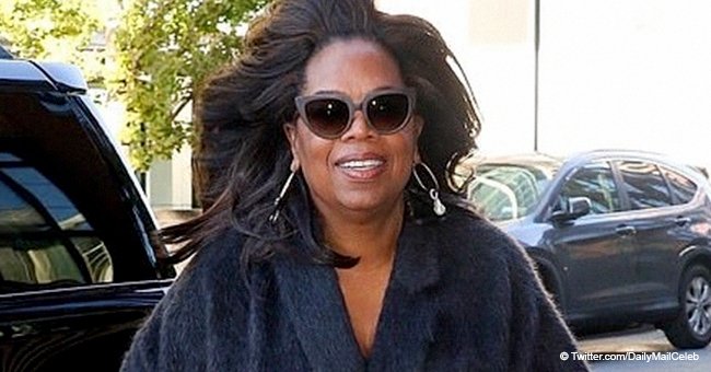 Oprah flaunts slimmer figure in navy cashmere cape and high heels after losing 42 pounds