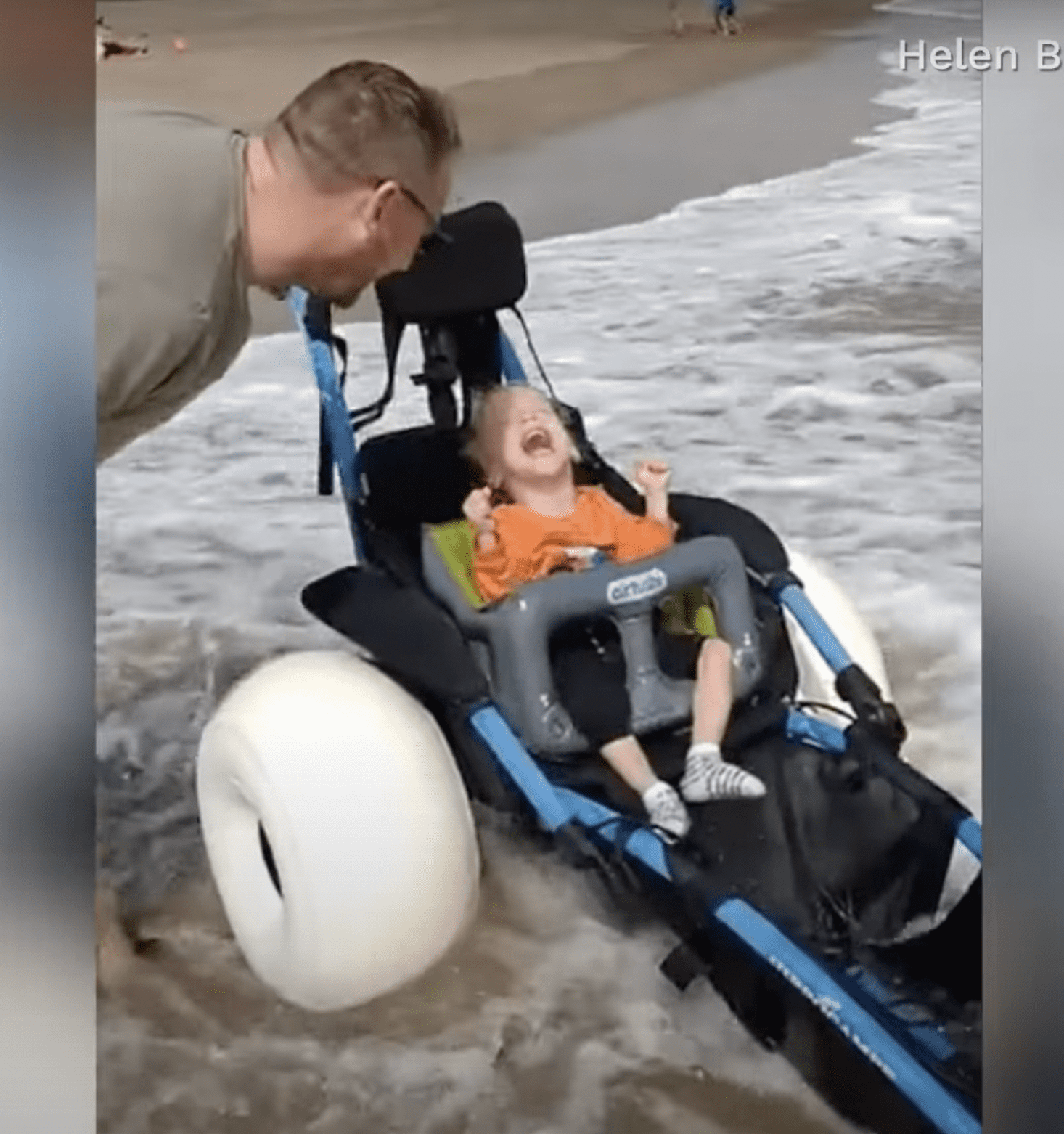 Little Joey Leathwood is seen giggling as the tumbling waves wash the shore. | Source: facebook.com/CBSNews