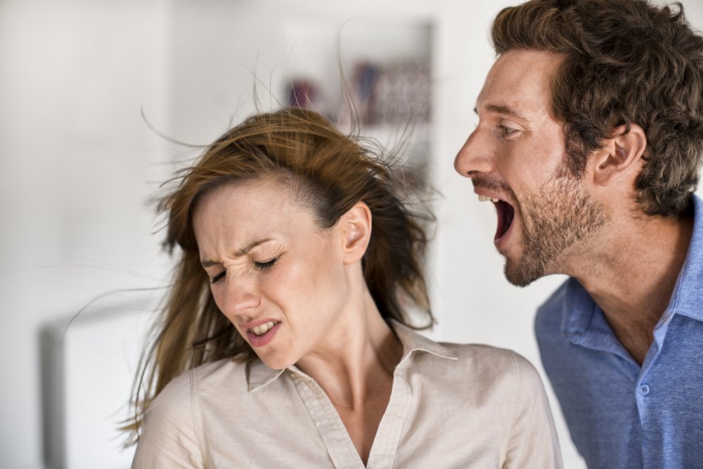 An angry man yelling at a woman. | Photo: Shutterstock
